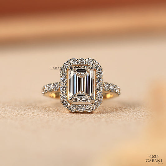 emerald cut lab grown diamond halo ring in 14k yellow gold with elongated center stone