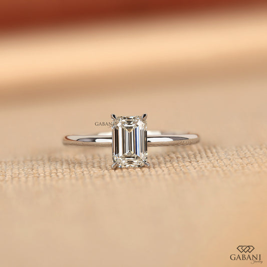 emerald cut lab grown diamond solitaire ring in 14k white gold with slim pipe shank design