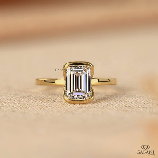 emerald cut lab grown diamond solitaire ring in yellow gold with half bezel setting