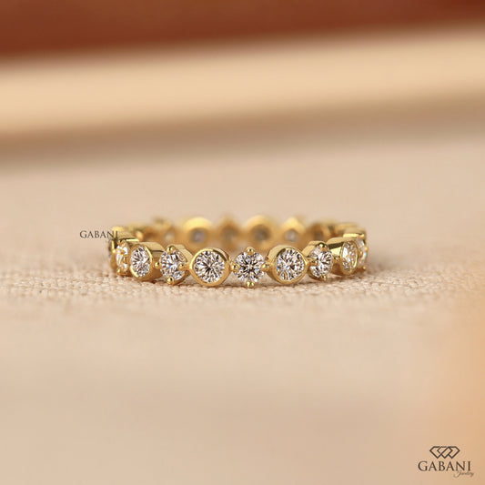 bezel set round lab grown diamond wedding band in 14k yellow gold with full eternity design and smooth polished finish