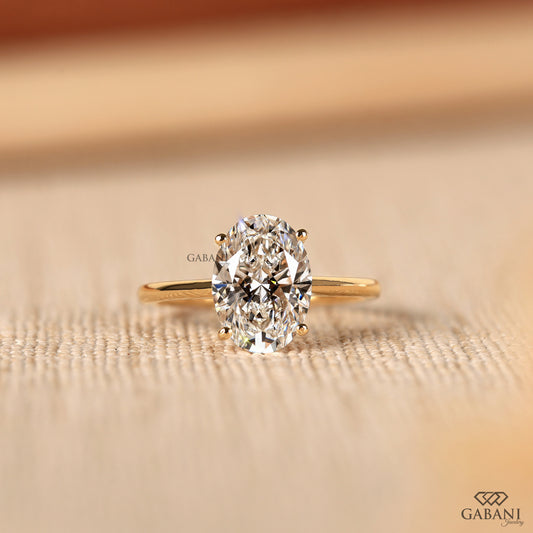 oval cut lab grown diamond solitaire engagement ring in 14k yellow gold with four prong setting