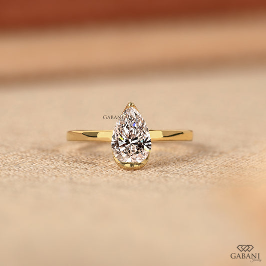 Pear cut lab grown diamond half bezel solitaire ring in yellow gold