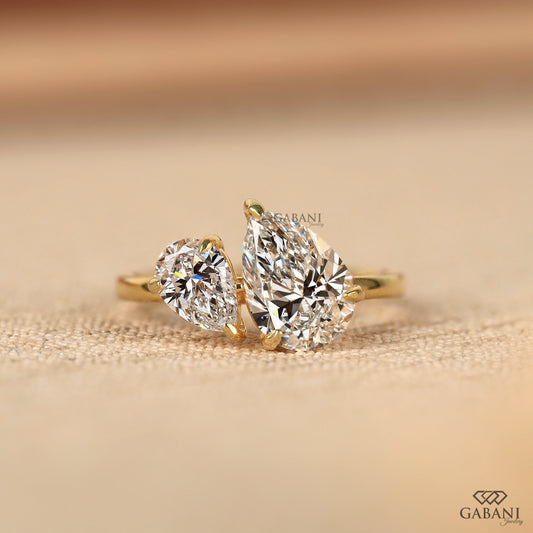 toi et moi ring with two pear shaped lab grown diamonds set side by side in solid yellow gold
