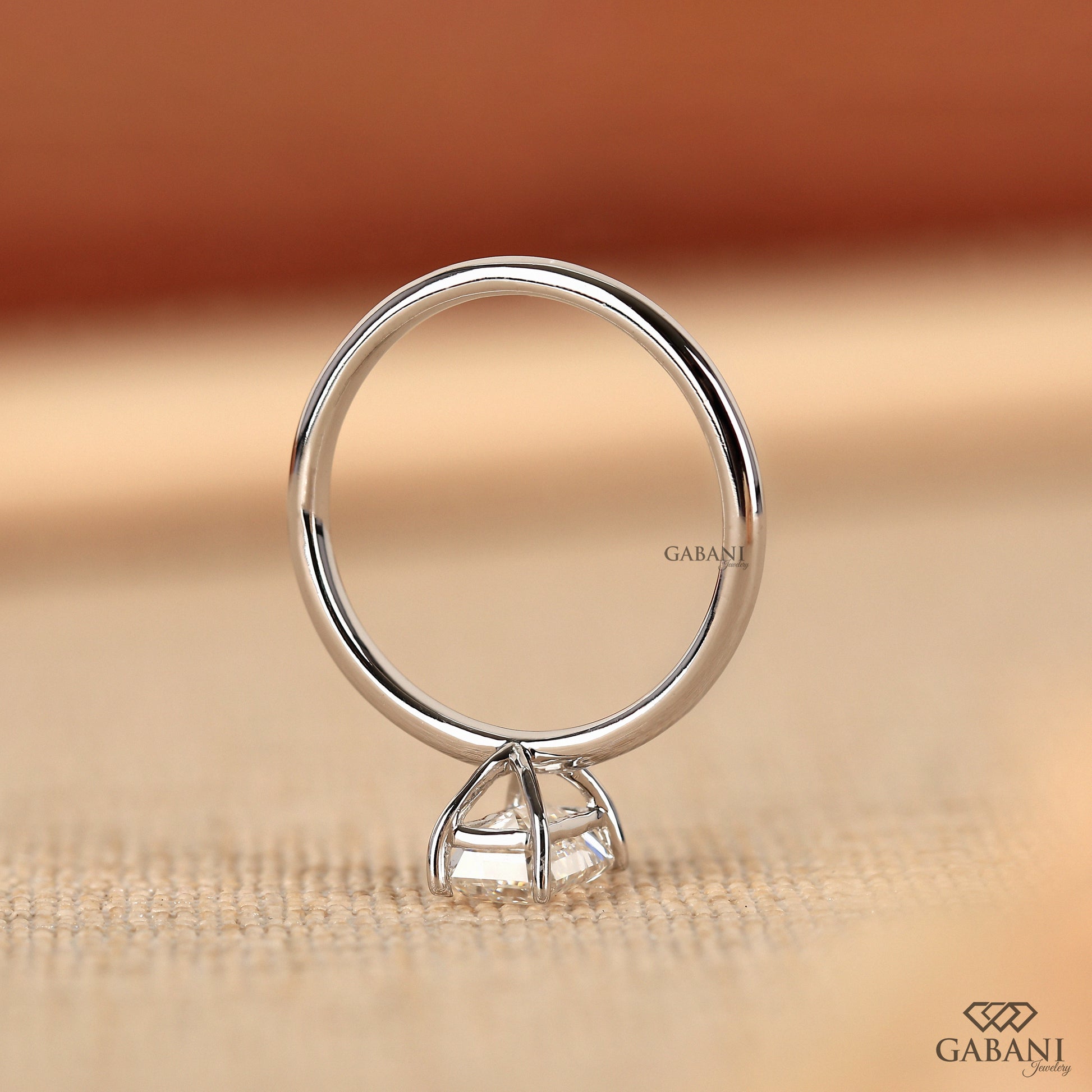 emerald cut lab grown diamond solitaire ring with slim white gold band