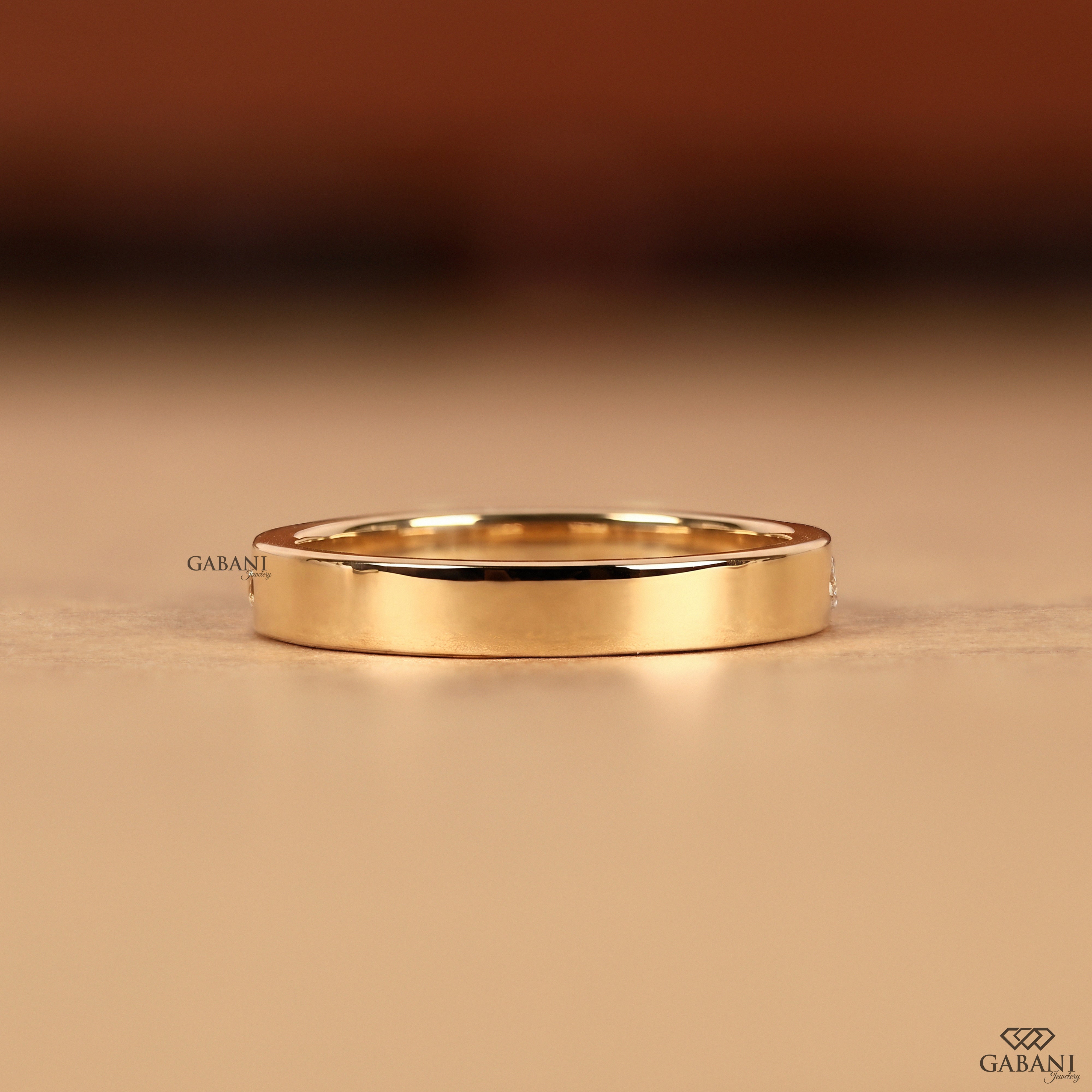 Multi shaped lab grown diamond band in solid 14K yellow gold with a flush setting designed as a stacking ring, wedding band, and anniversary ring.