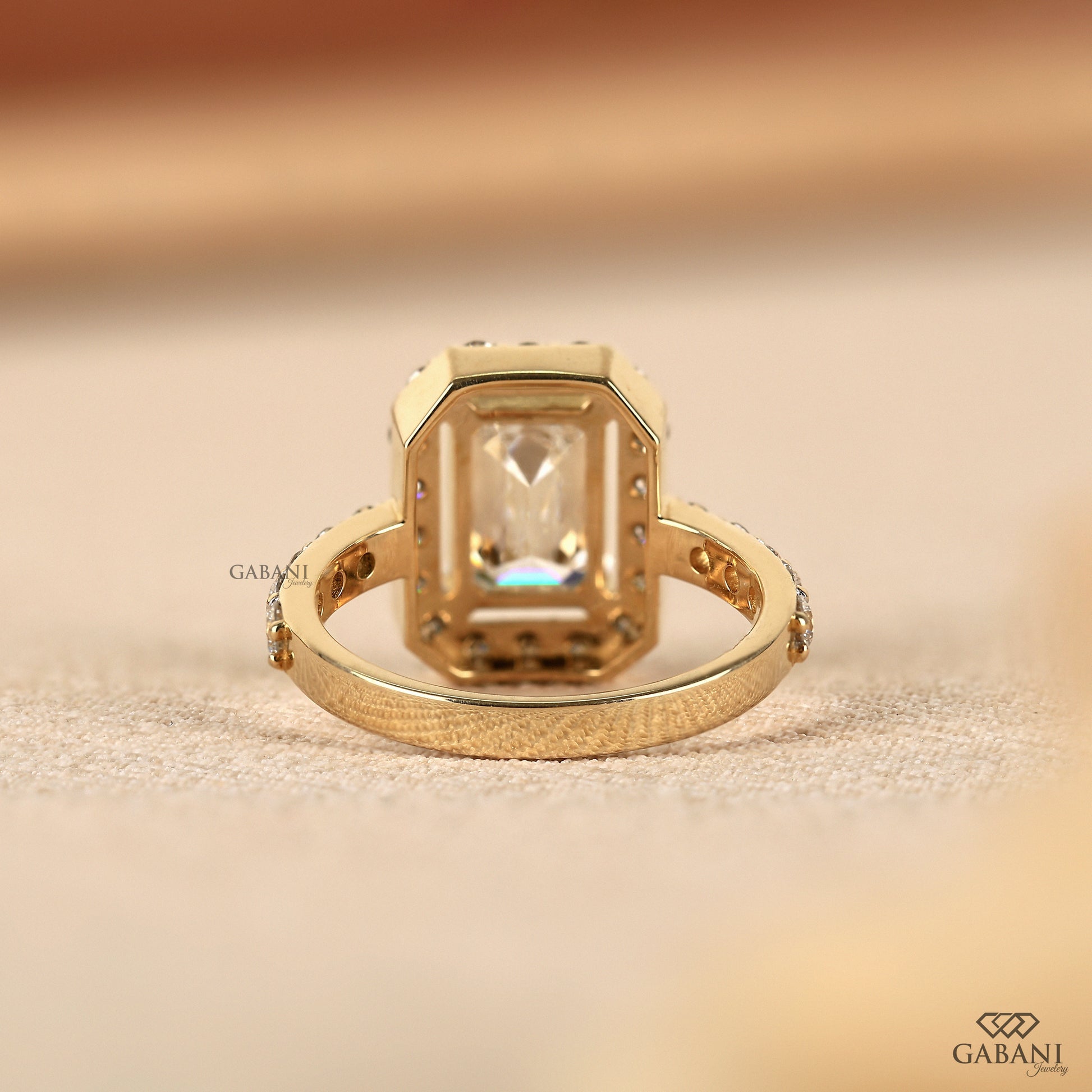 14k yellow gold ring featuring emerald cut lab grown diamond and halo surround