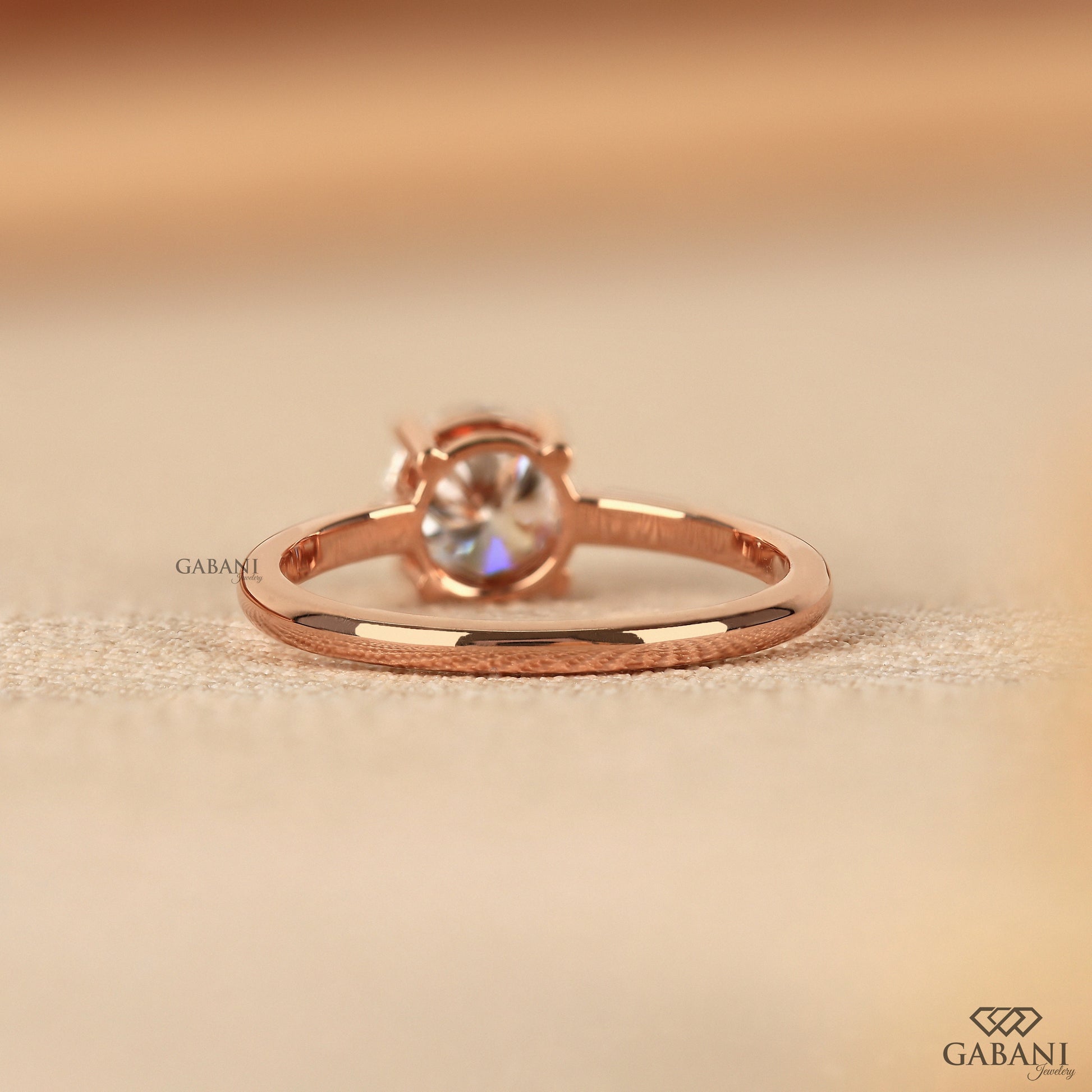 rose gold solitaire ring featuring round lab grown diamond in four button prongs
