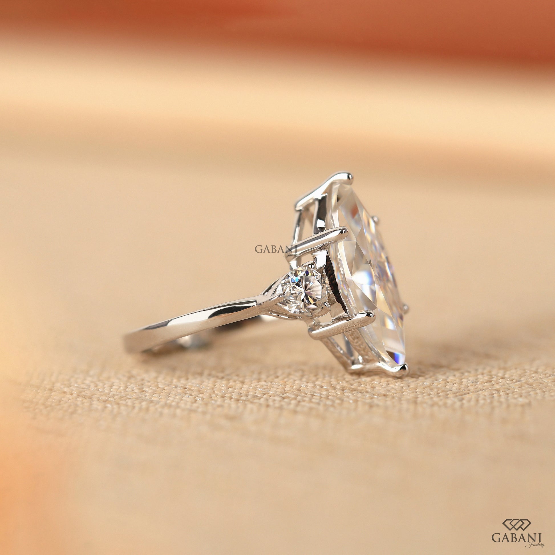 Three stone lab grown diamond ring in 18K white gold with marquise center and balanced pear accents