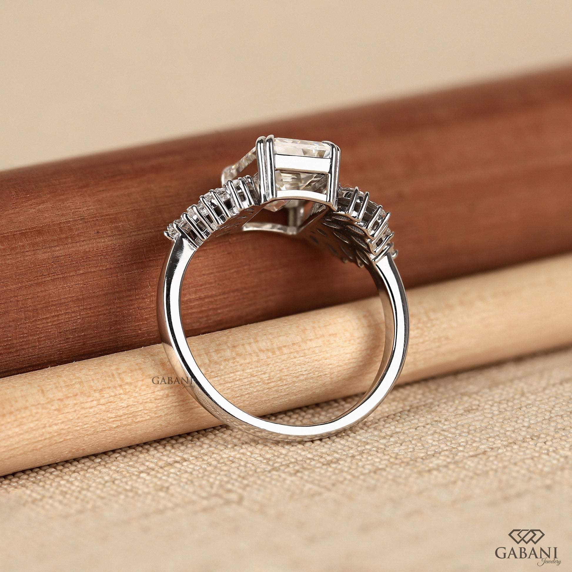 emerald cut lab diamond ring with elevated gallery and marquise side stones