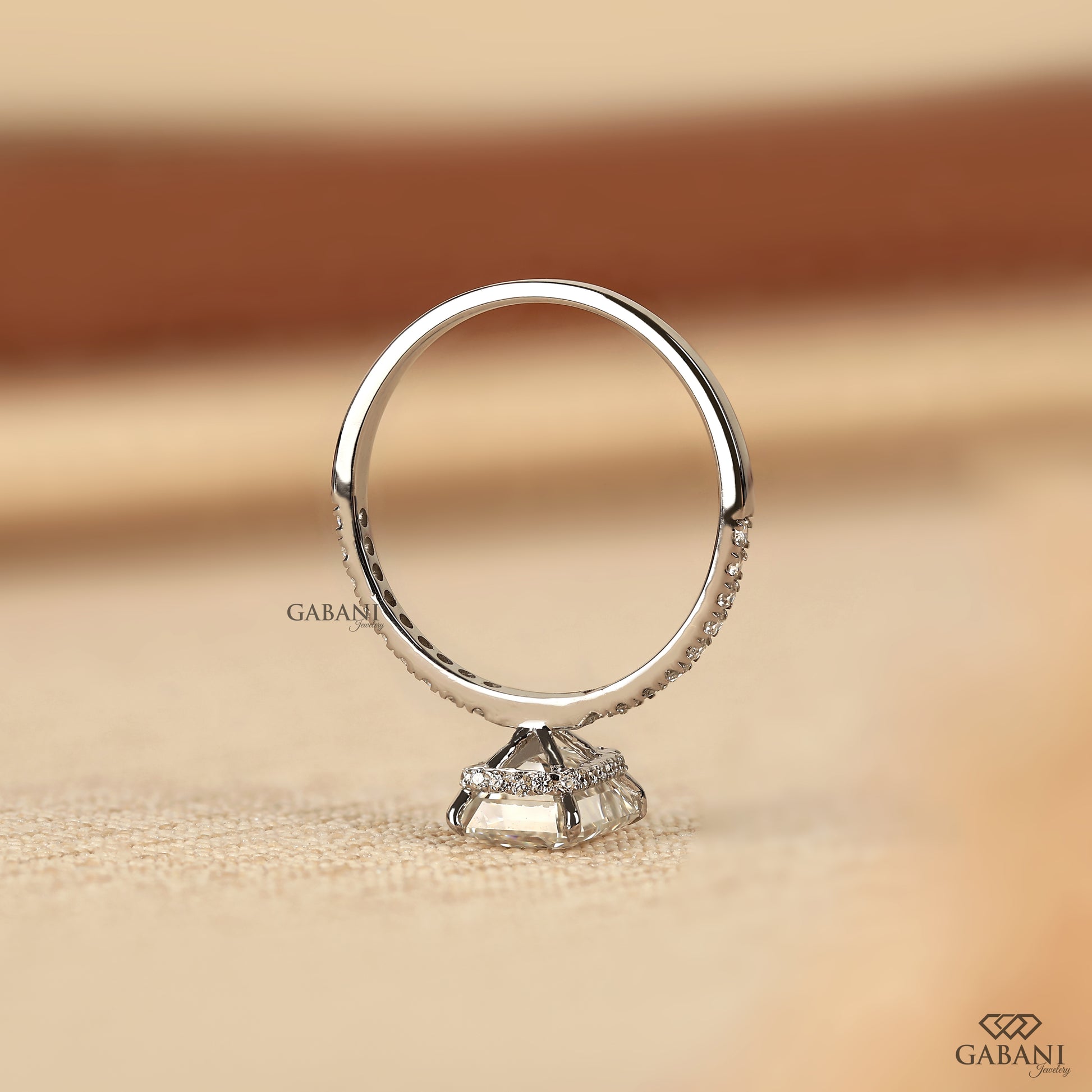 white gold solitaire ring with emerald cut lab created diamond and delicate pave band