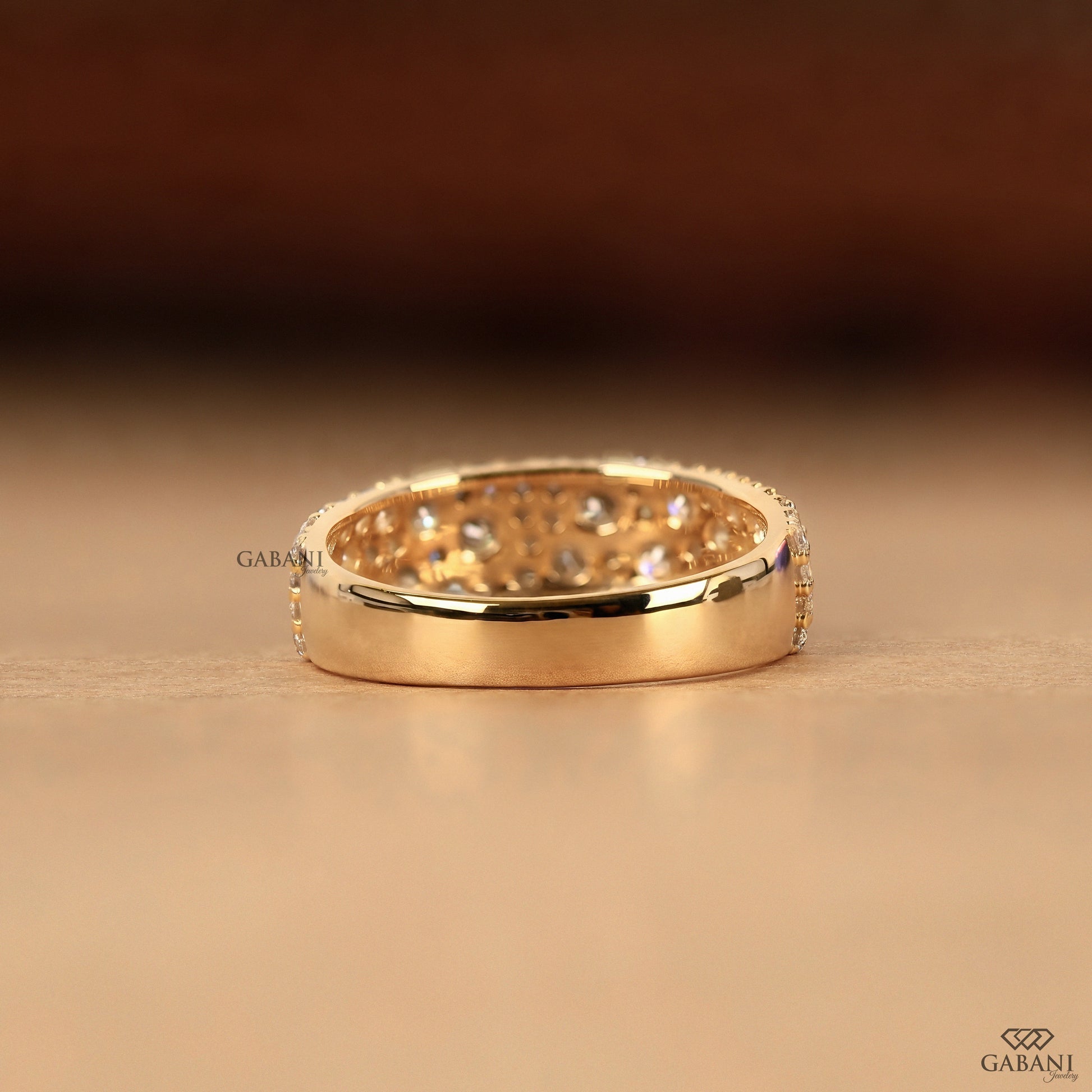 solid gold wide band with scattered round lab diamonds in pave setting