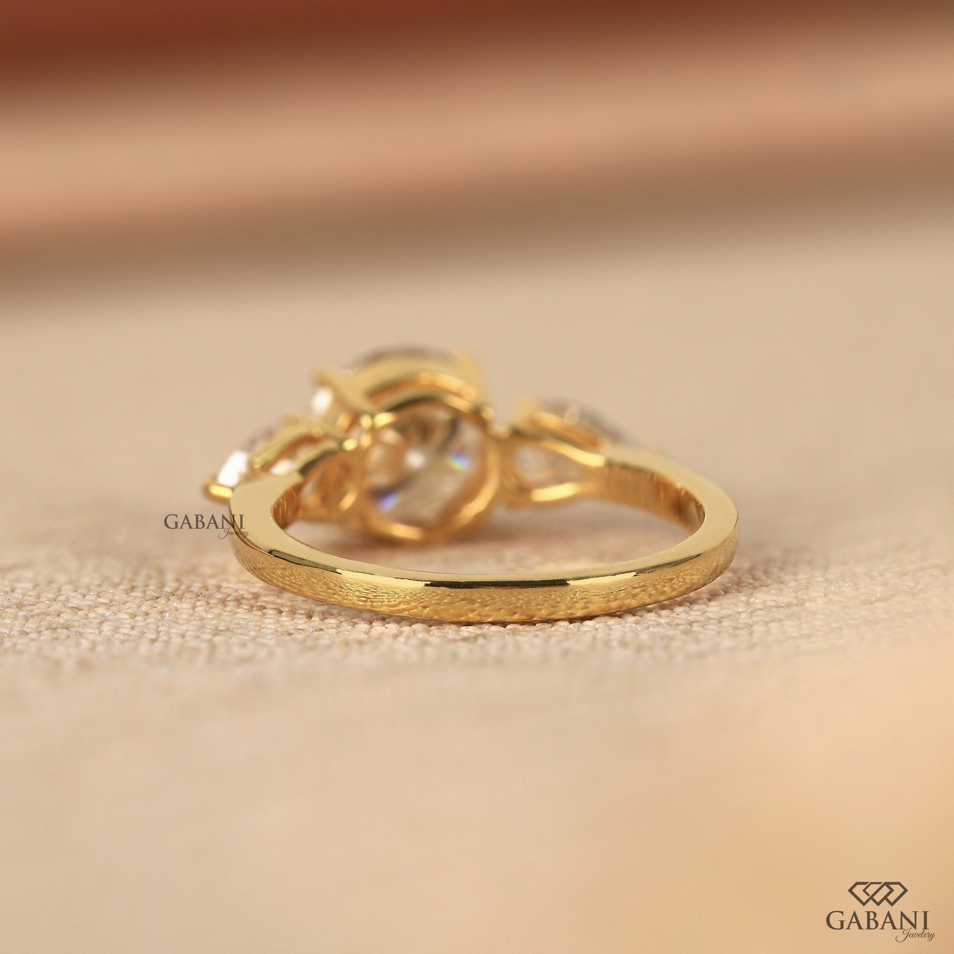 round and pear lab grown diamond ring with cathedral shank in solid 14k yellow gold