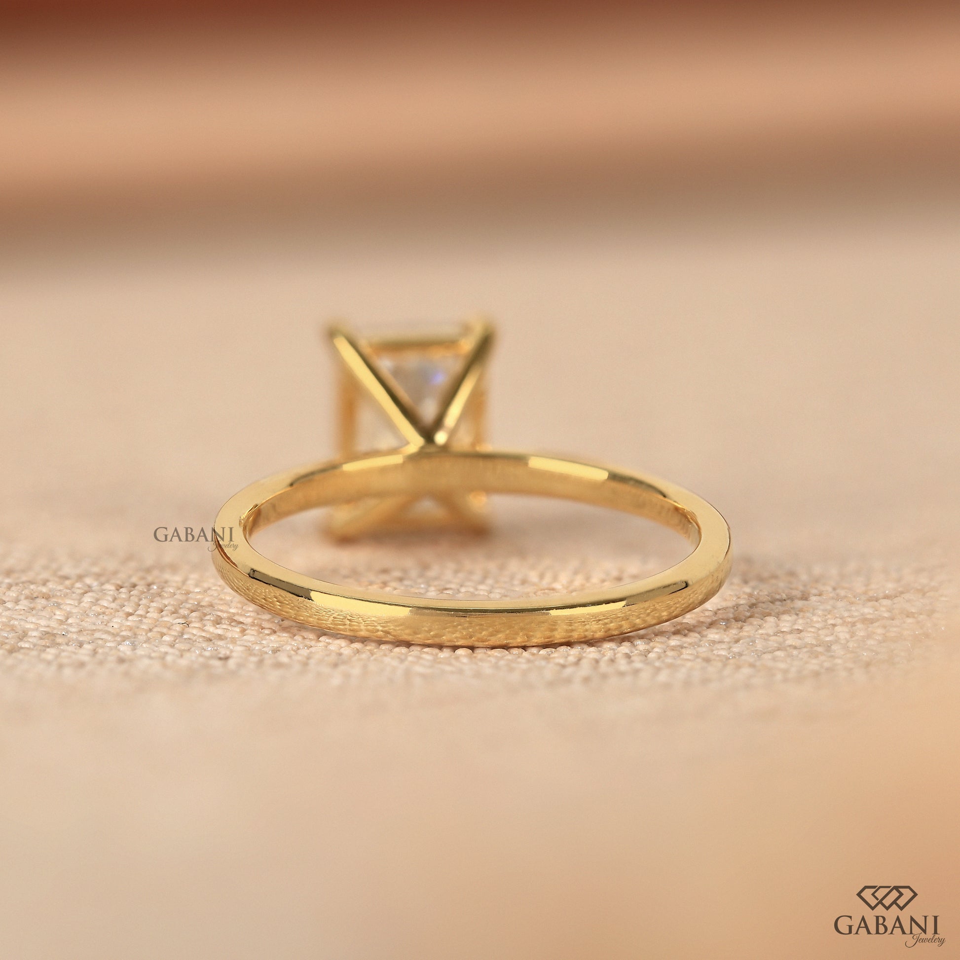 Elegant emerald cut lab grown diamond solitaire in yellow gold
