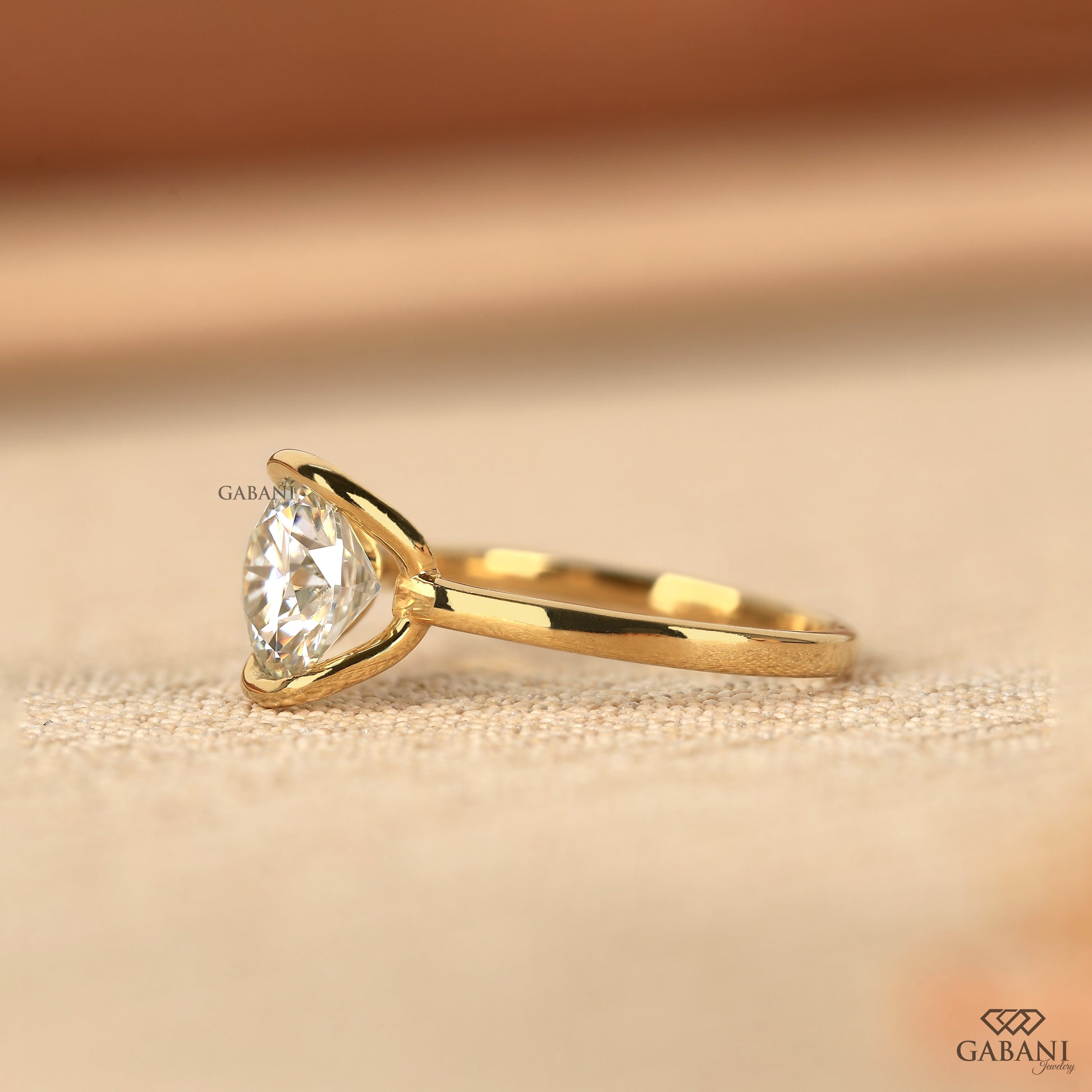 round cut lab grown diamond ring in half bezel yellow gold setting
