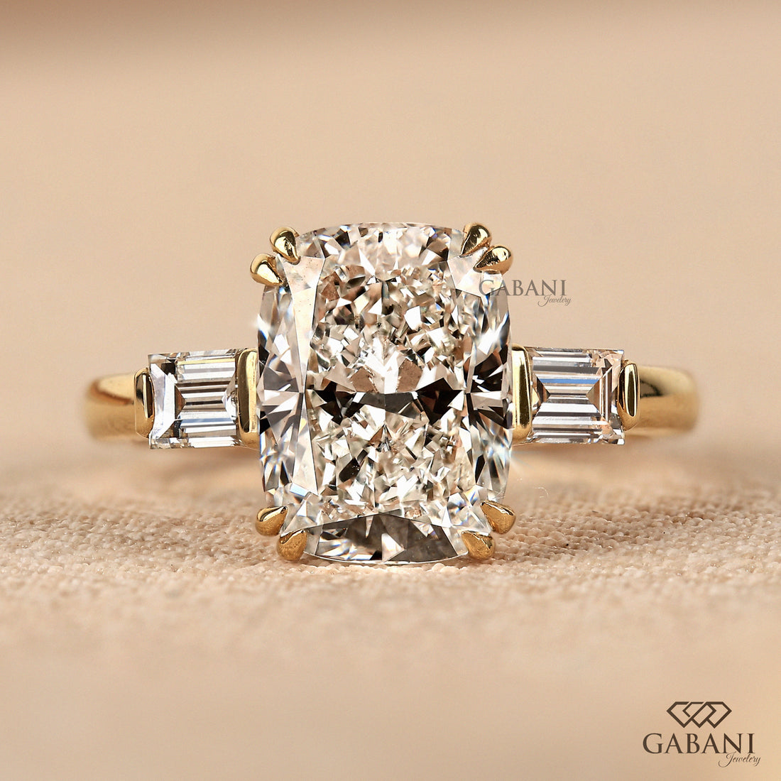 Front top view of 14K yellow gold three stone cushion cut lab grown diamond ring