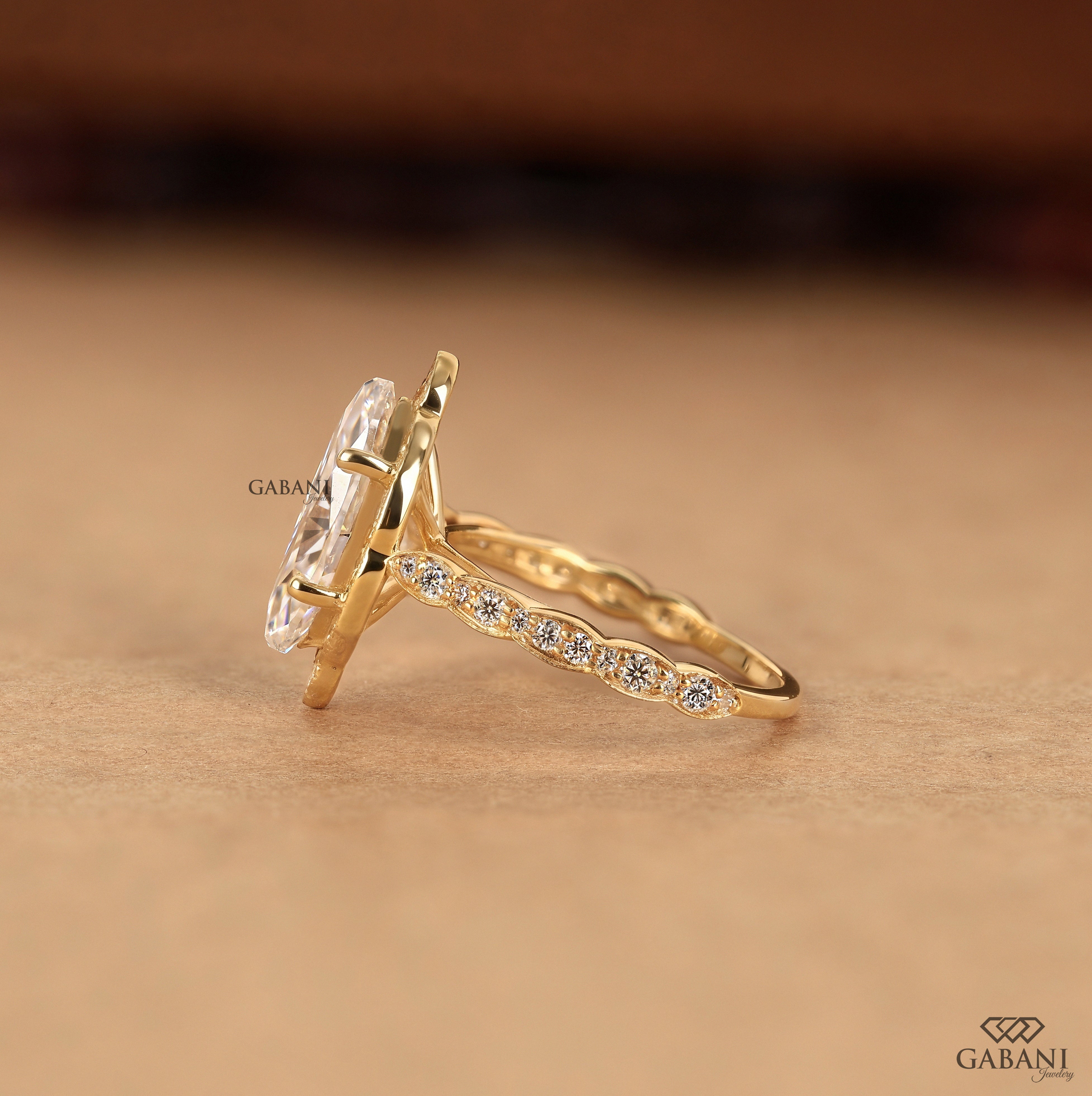 Lab grown diamond engagement ring with marquise center and pave halo