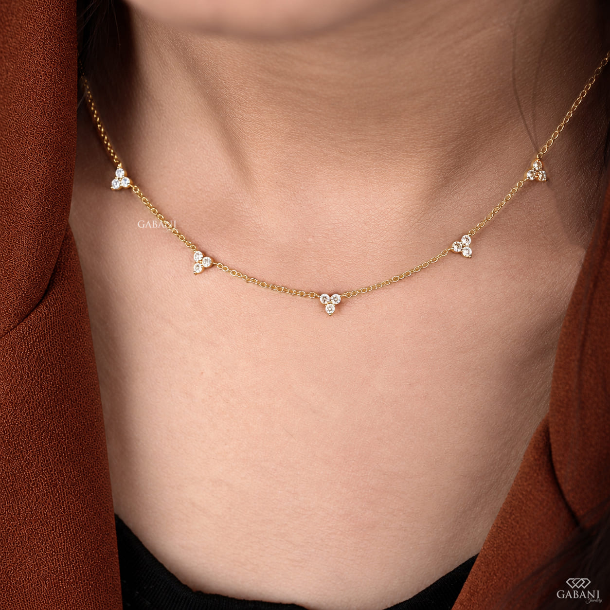18K yellow gold lab grown diamond station necklace featuring round cut three stone floral clusters on a delicate gold chain.