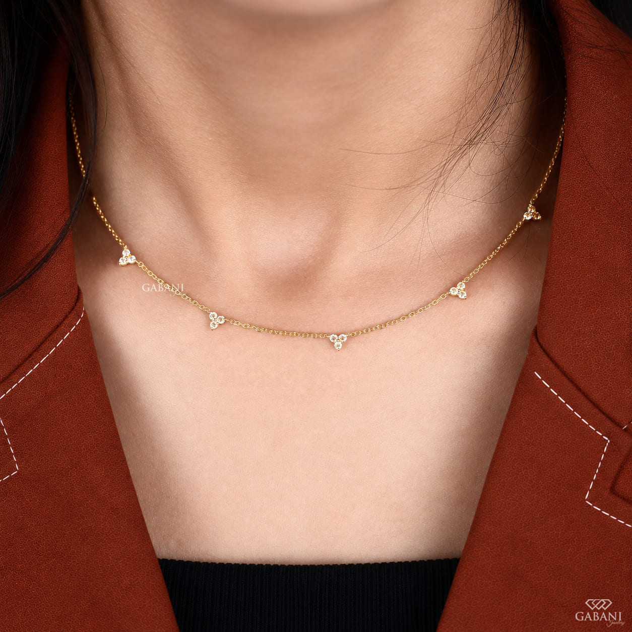 18K yellow gold lab grown diamond station necklace featuring round cut three stone floral clusters on a delicate gold chain.