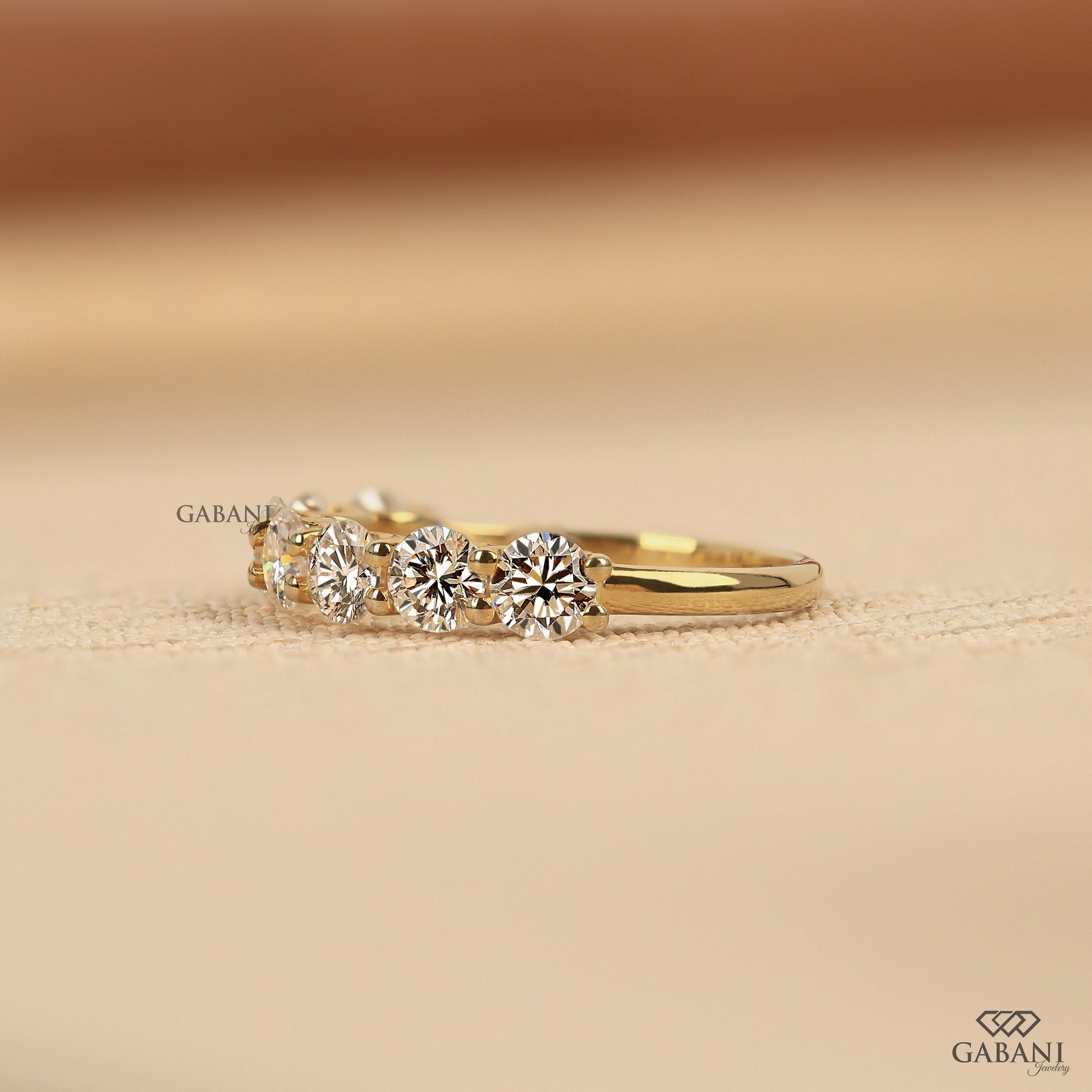 lab grown diamond half eternity band with seven round cut stones set in yellow gold