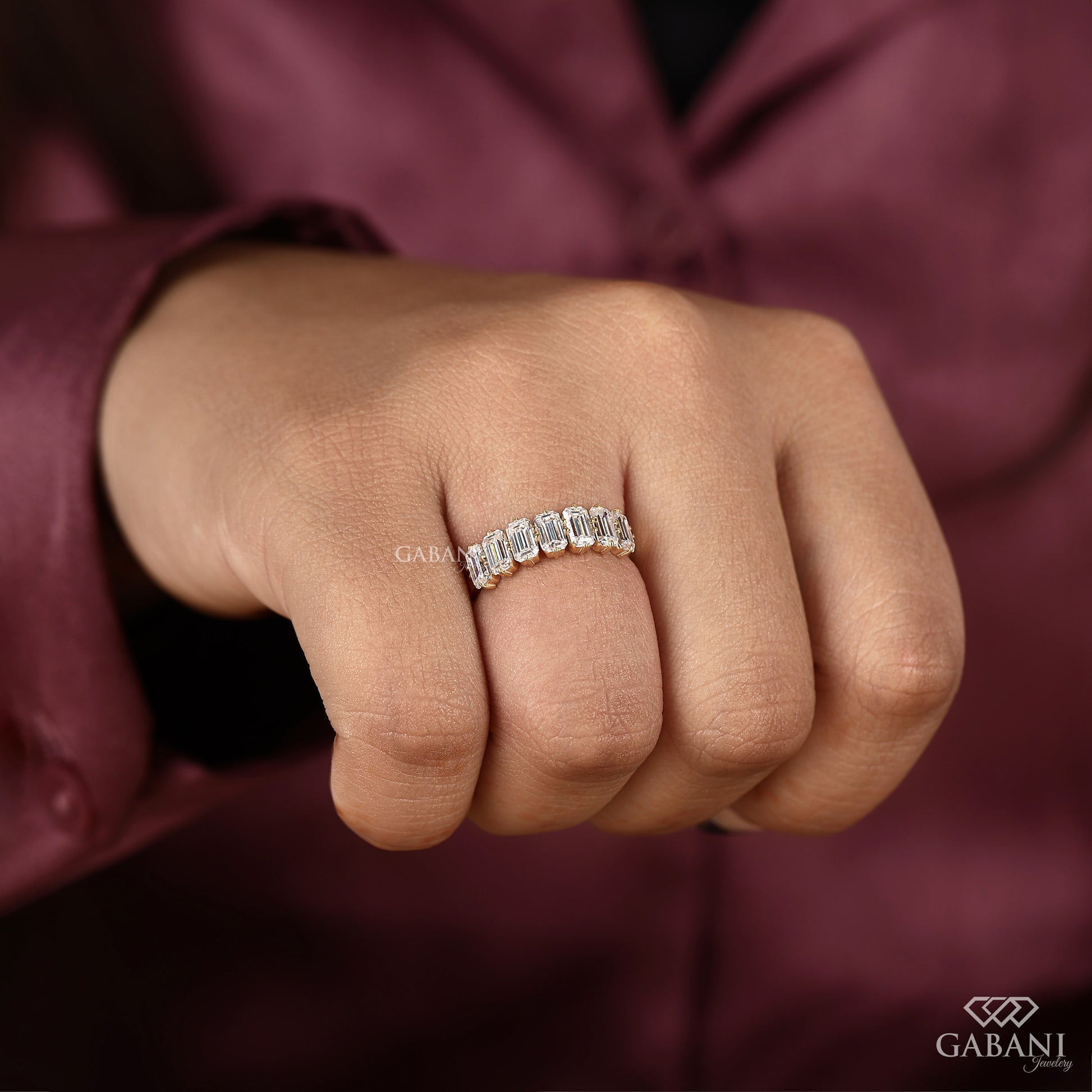Yellow gold half eternity band with seven emerald cut certified lab grown diamonds