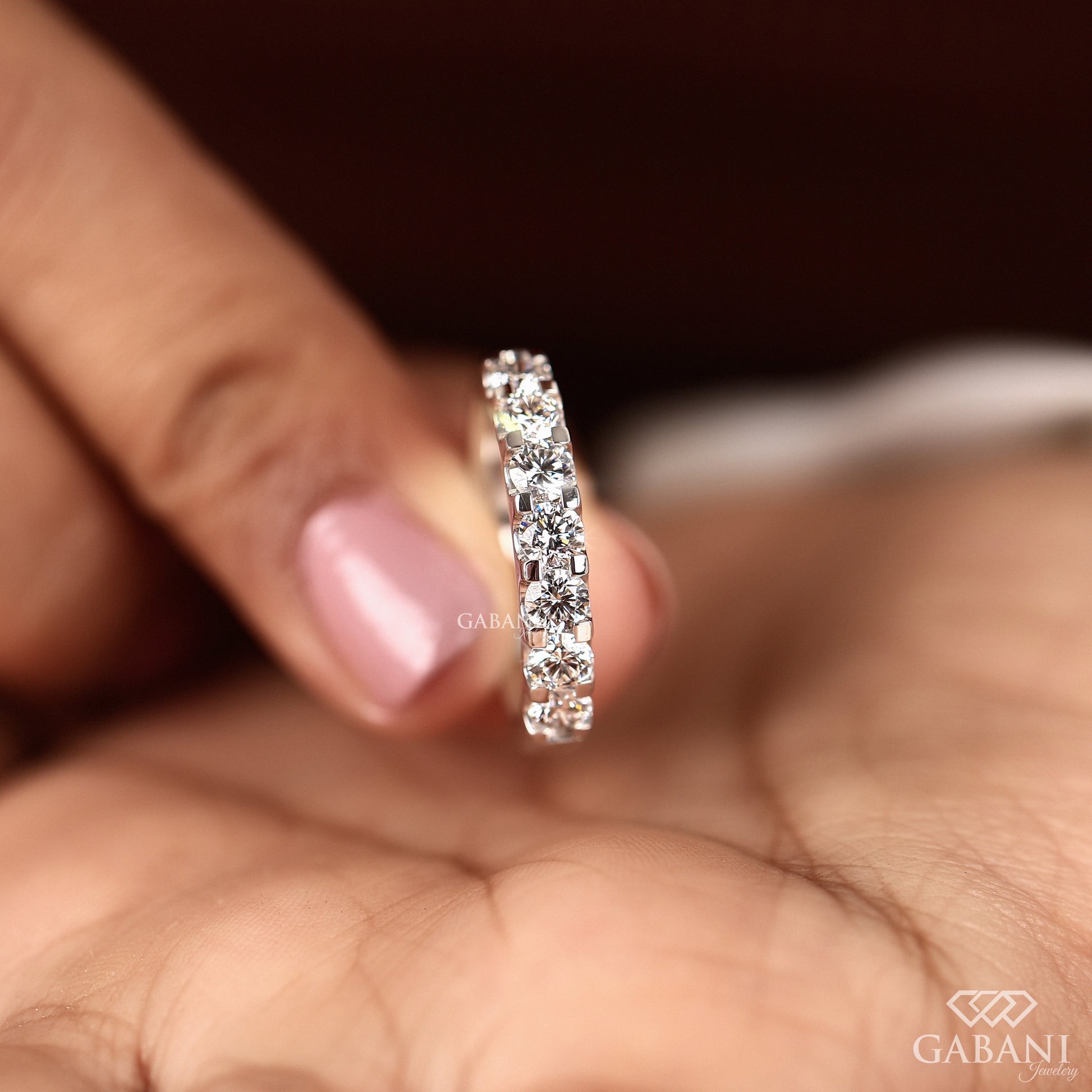 round cut lab grown diamond band with seven stones in French pavé set smooth white gold band