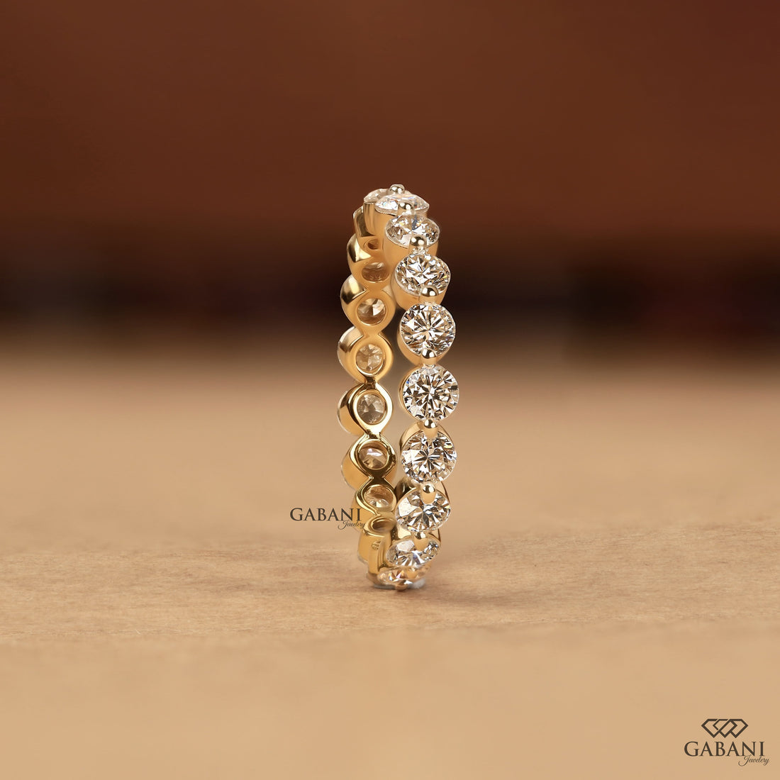 Round cut lab grown diamond full eternity wedding band in yellow gold with shared prong setting.
