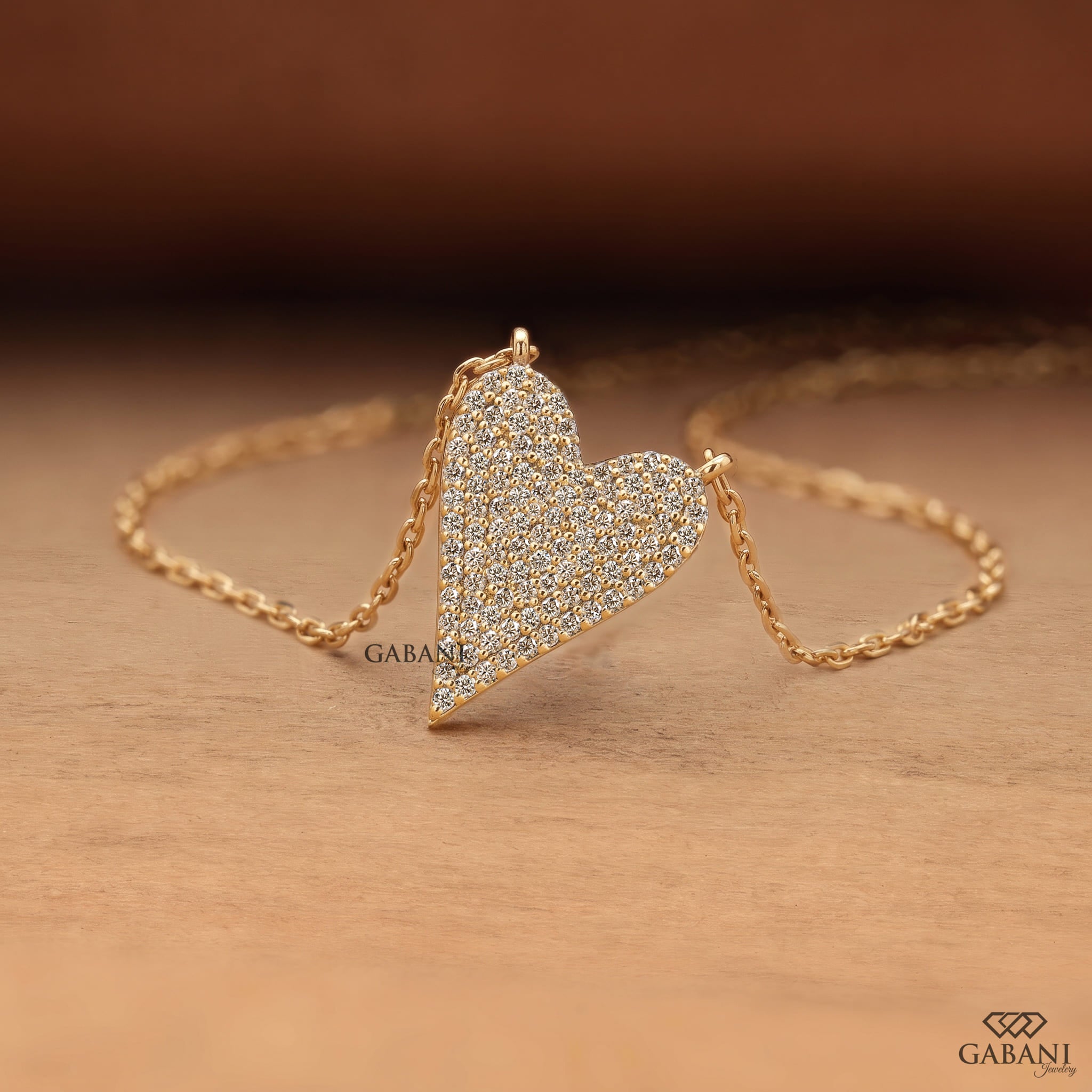 Heart shaped lab grown diamond pendant necklace in yellow gold with sparkling round cut diamonds and a delicate cable chain.