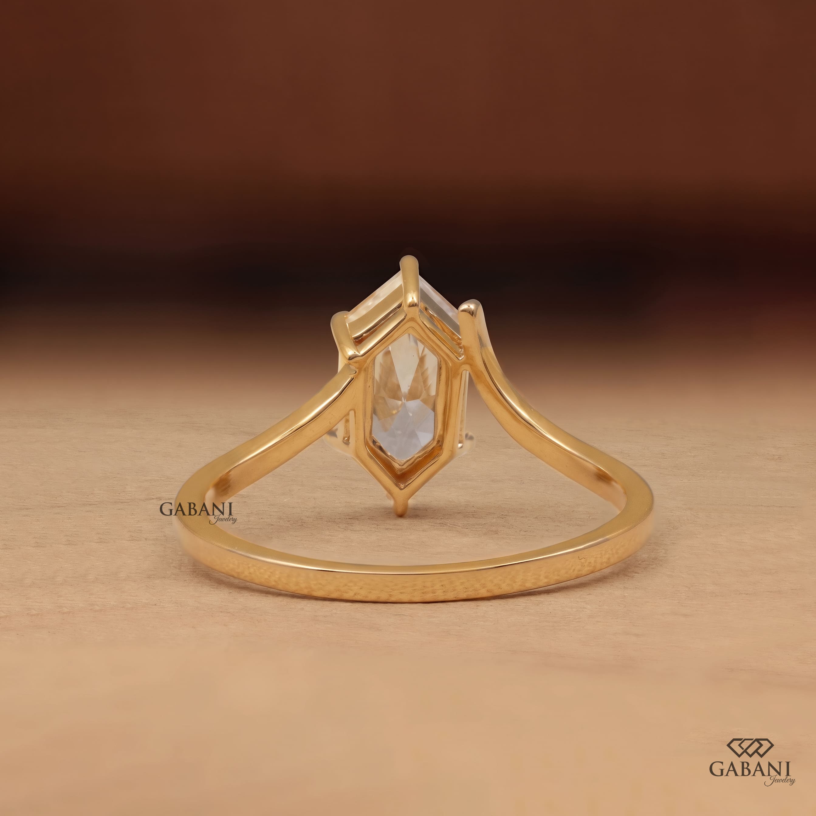 Marquise cut lab grown diamond solitaire engagement ring with six prong setting, curved shank and polished yellow gold band.
