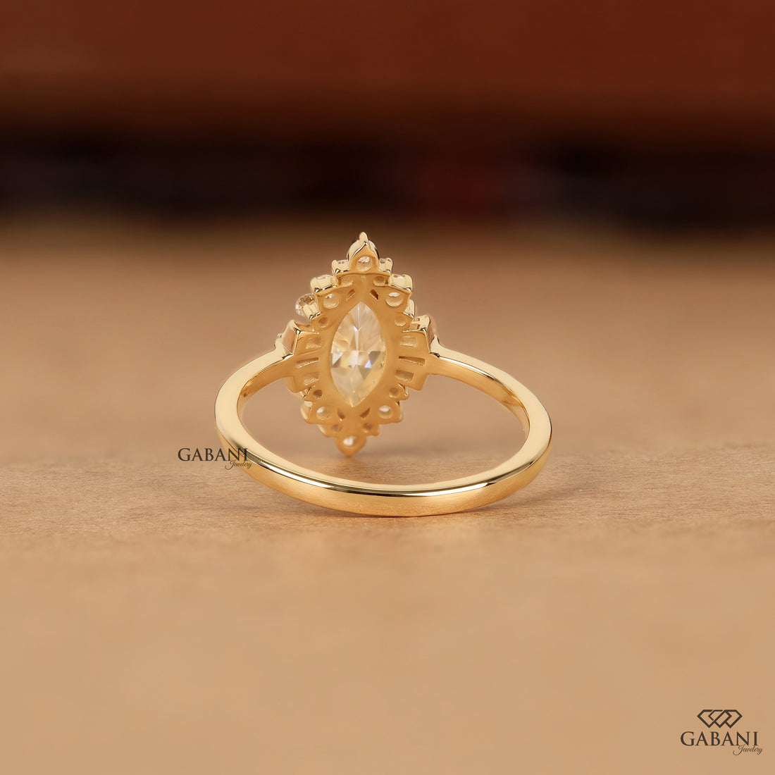 Marquise lab grown diamond engagement ring with floral halo, baguette side stones and yellow gold band, IGI certified EF color VS1 clarity.