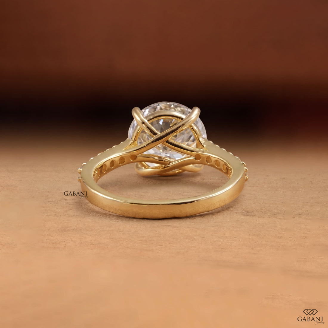 Round Portuguese cut lab grown diamond cathedral engagement ring in yellow gold with a four-prong center setting and pave diamond shoulders.
