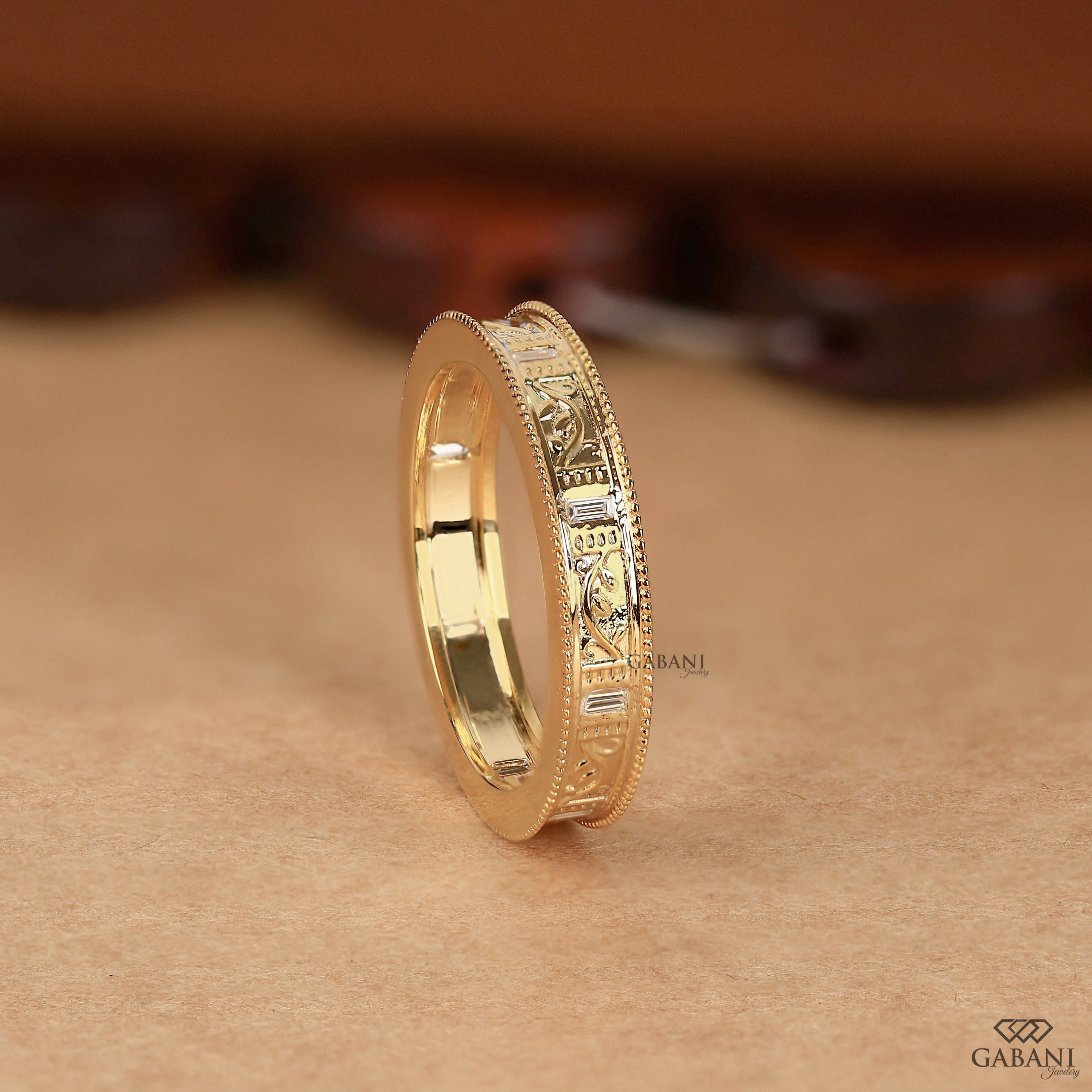 Baguette cut lab grown diamond wedding band with vintage floral engraving, milgrain edges, and polished yellow gold finish.