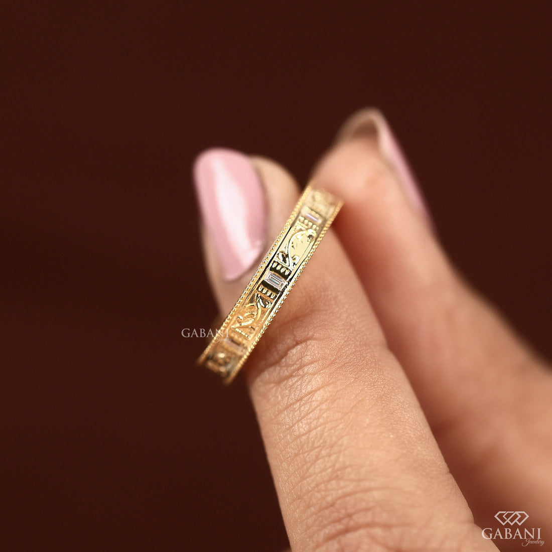 Baguette cut lab grown diamond wedding band with vintage floral engraving, milgrain edges, and polished yellow gold finish.