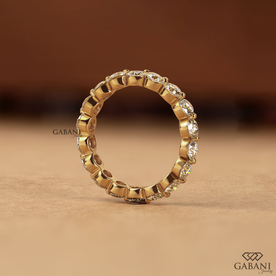 Round lab grown diamond shared prong full eternity wedding band in yellow gold with continuous diamond setting.