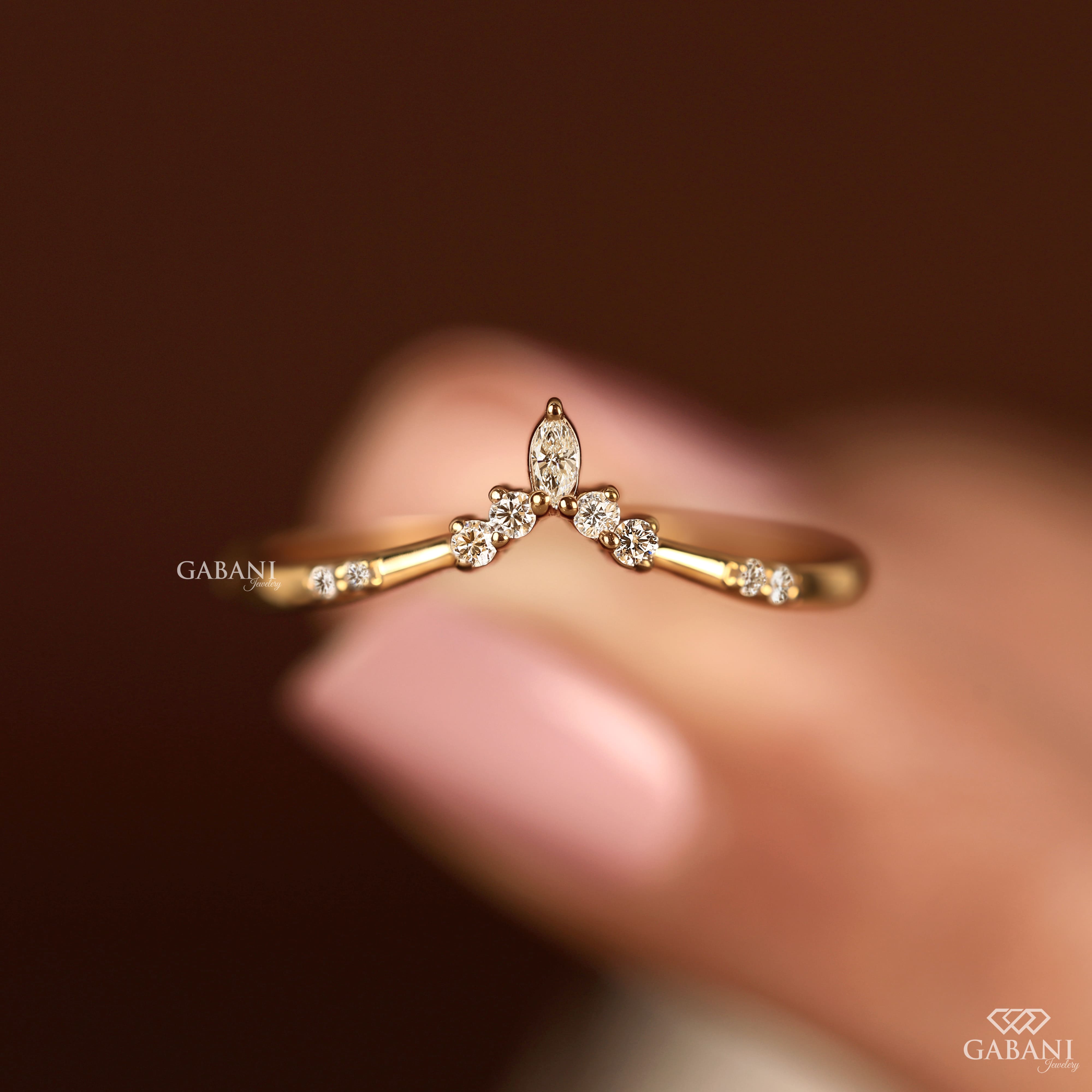 Marquise and round cut lab grown diamond curved wedding band in yellow gold with V shaped contour design for stacking with an engagement ring.