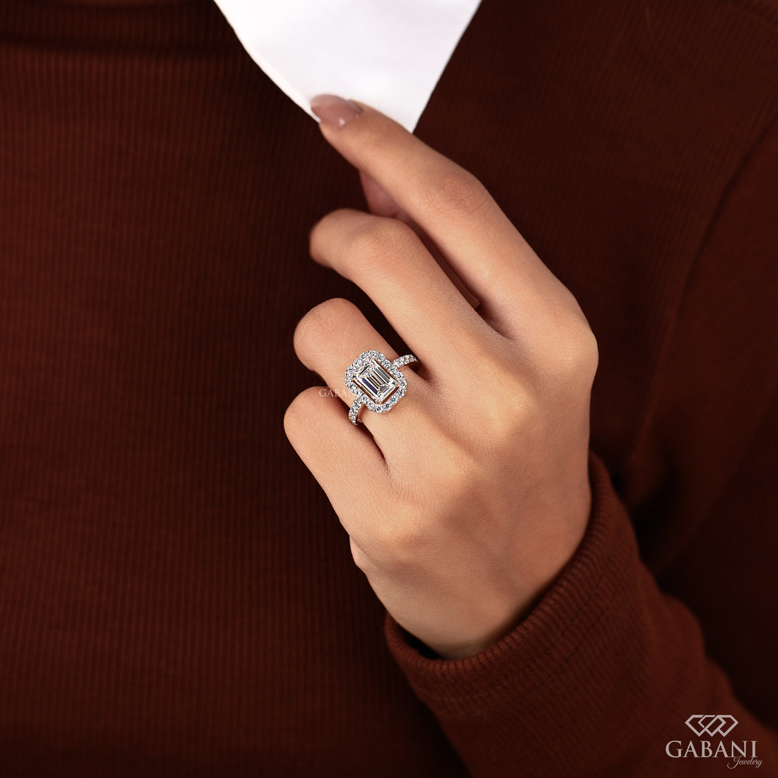 Emerald cut lab grown diamond engagement ring with round diamond halo, pave side stones, yellow gold band, IGI certified EF color VS1 clarity.