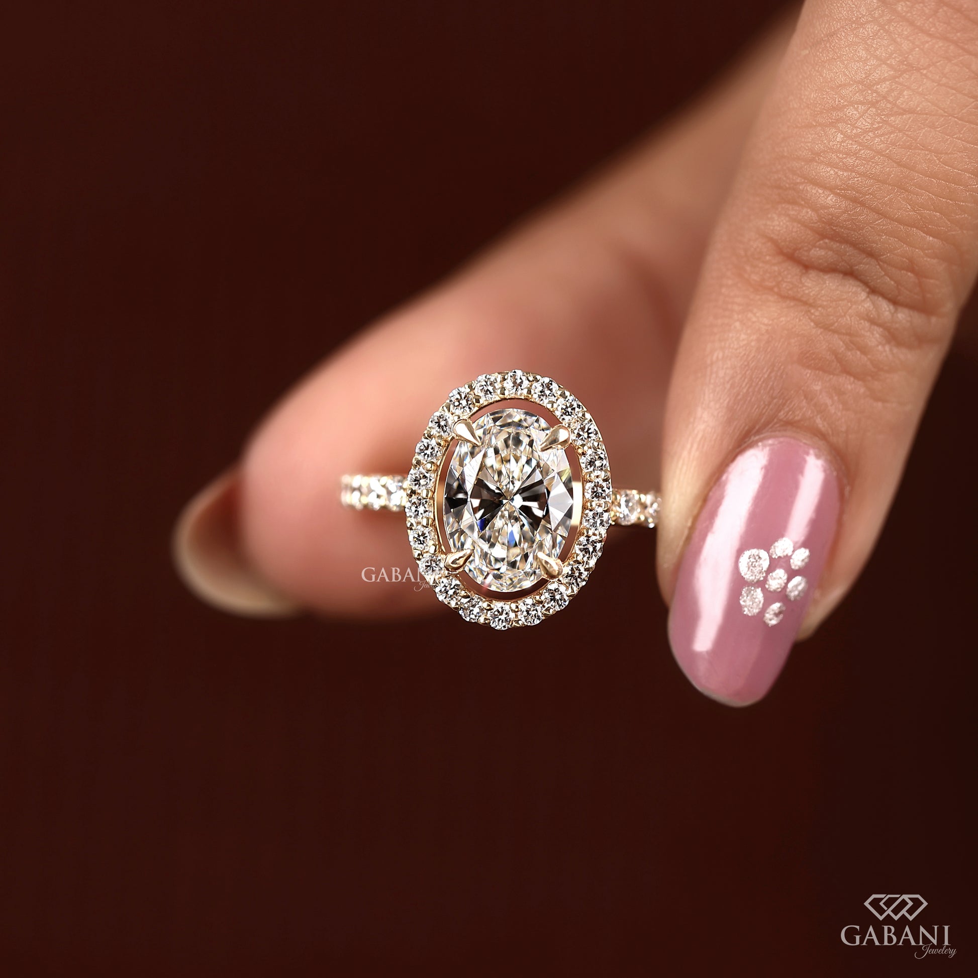 Oval diamond ring featuring lab grown center stone and halo design