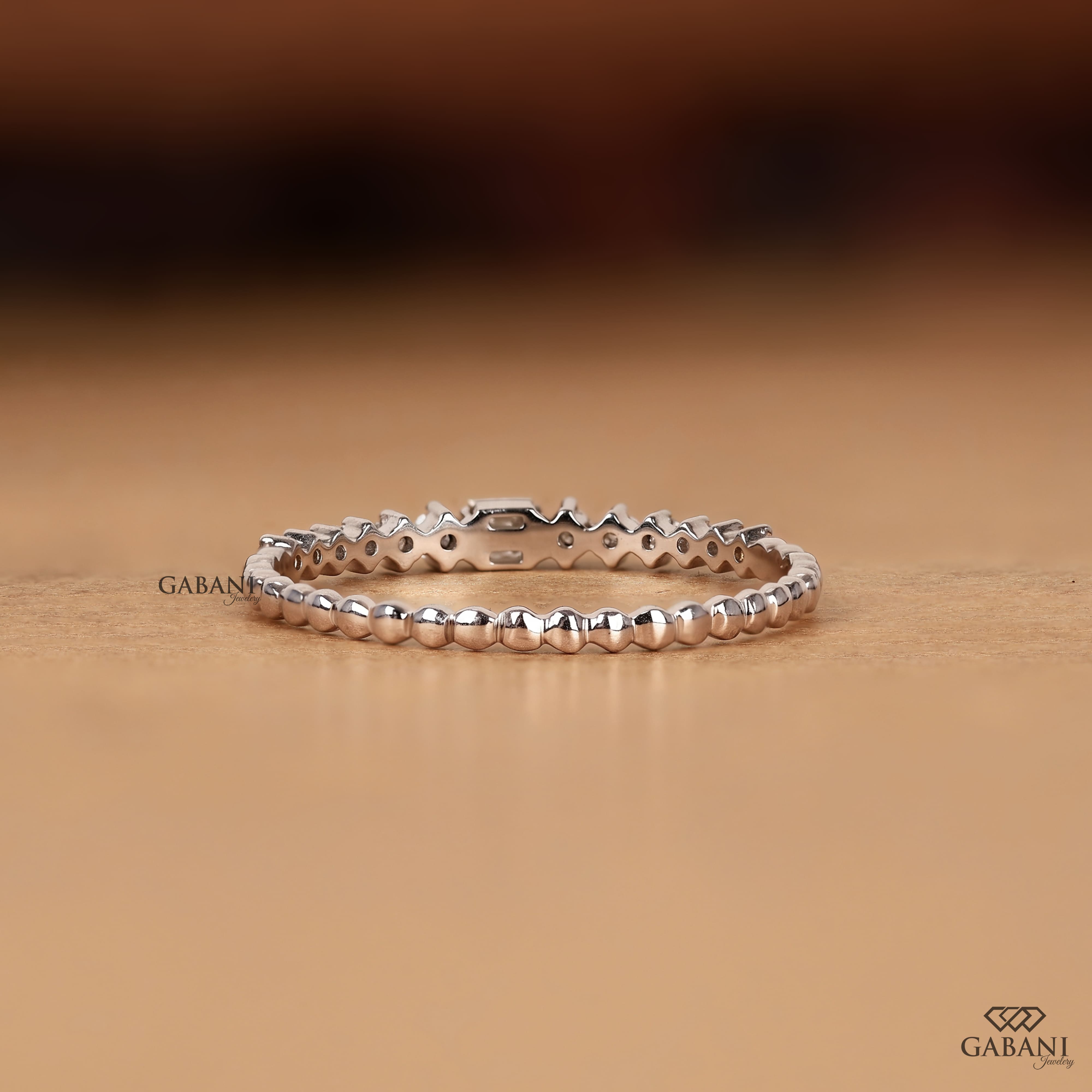 Princess cut and round lab grown diamond wedding band in white gold with graduated prong set diamond design.