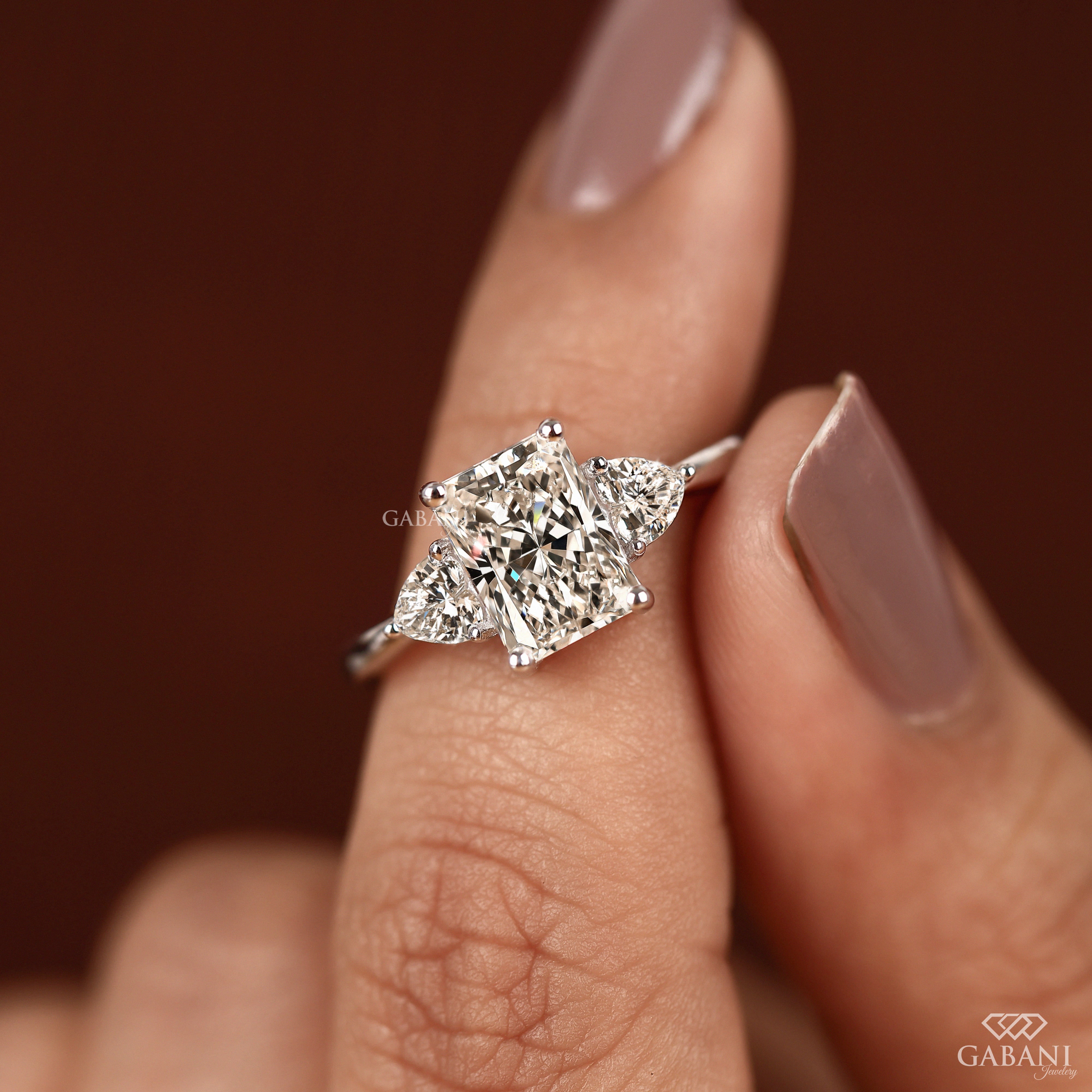 Radiant cut lab grown diamond engagement ring with heart shaped side stones
