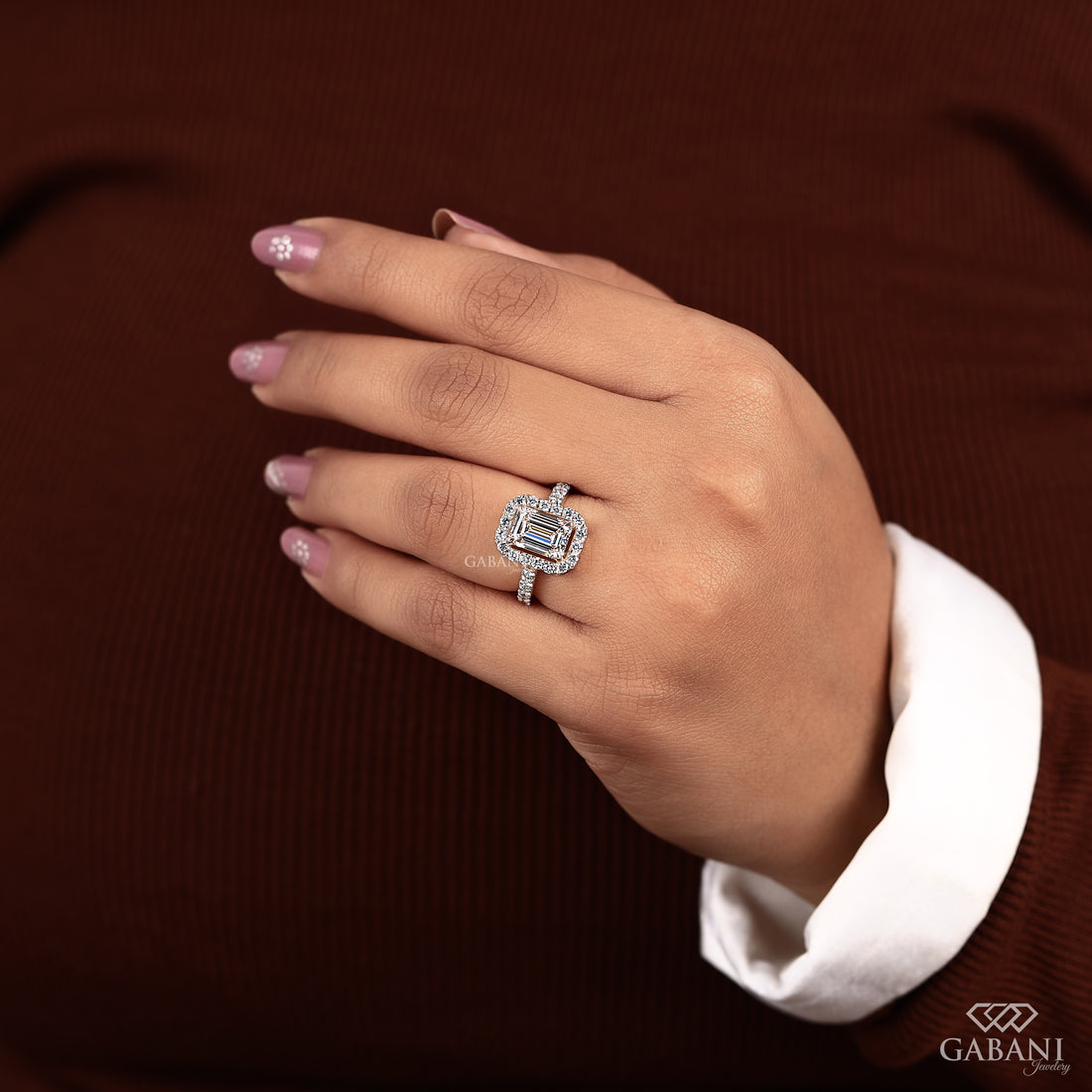 Emerald cut lab grown diamond engagement ring with round diamond halo, pave side stones, yellow gold band, IGI certified EF color VS1 clarity.
