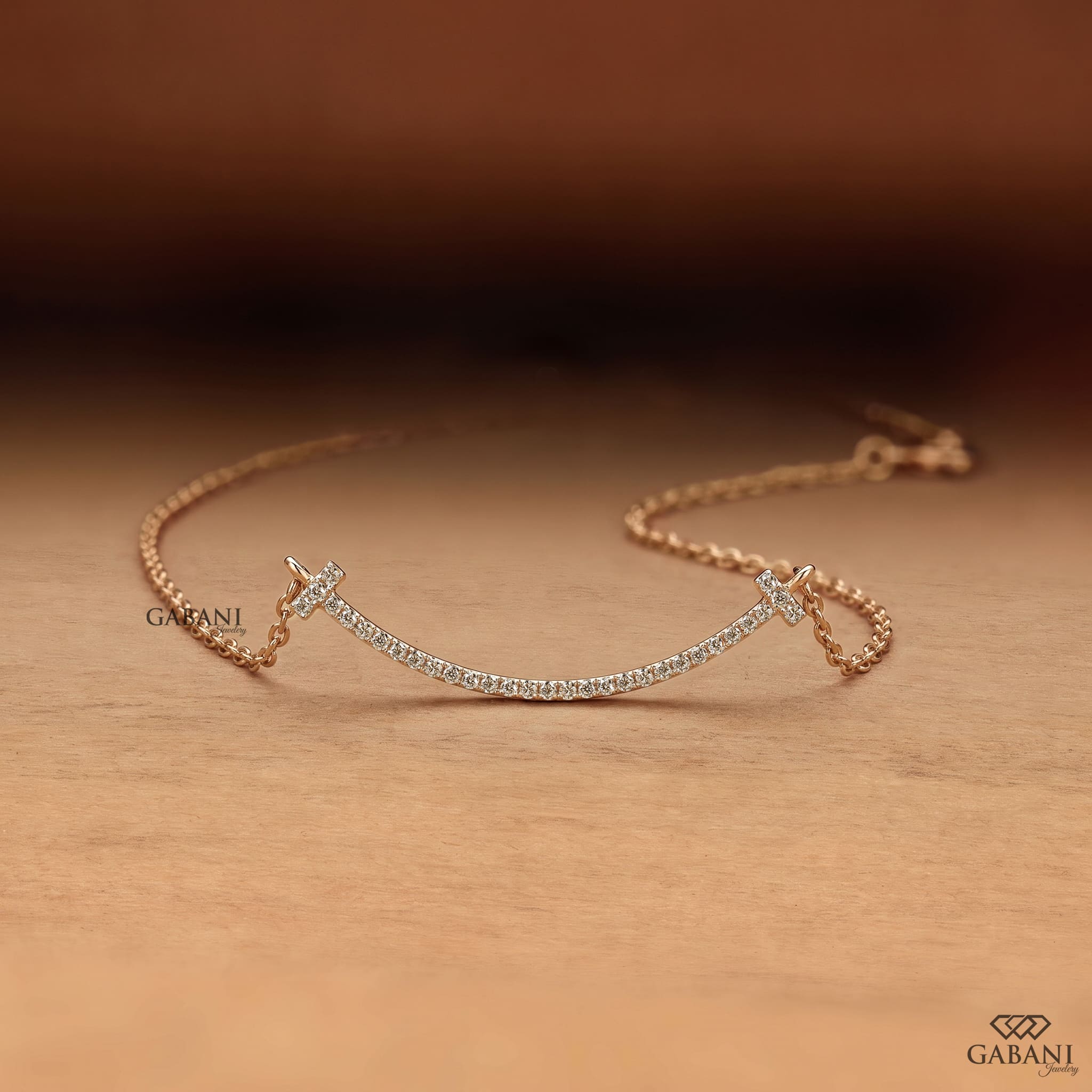 Curved bar lab grown diamond necklace in yellow gold featuring round pavé set diamonds, T-shaped ends and a delicate gold chain.