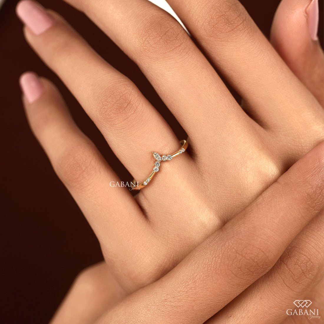Marquise and round cut lab grown diamond curved wedding band in yellow gold with V shaped contour design for stacking with an engagement ring.