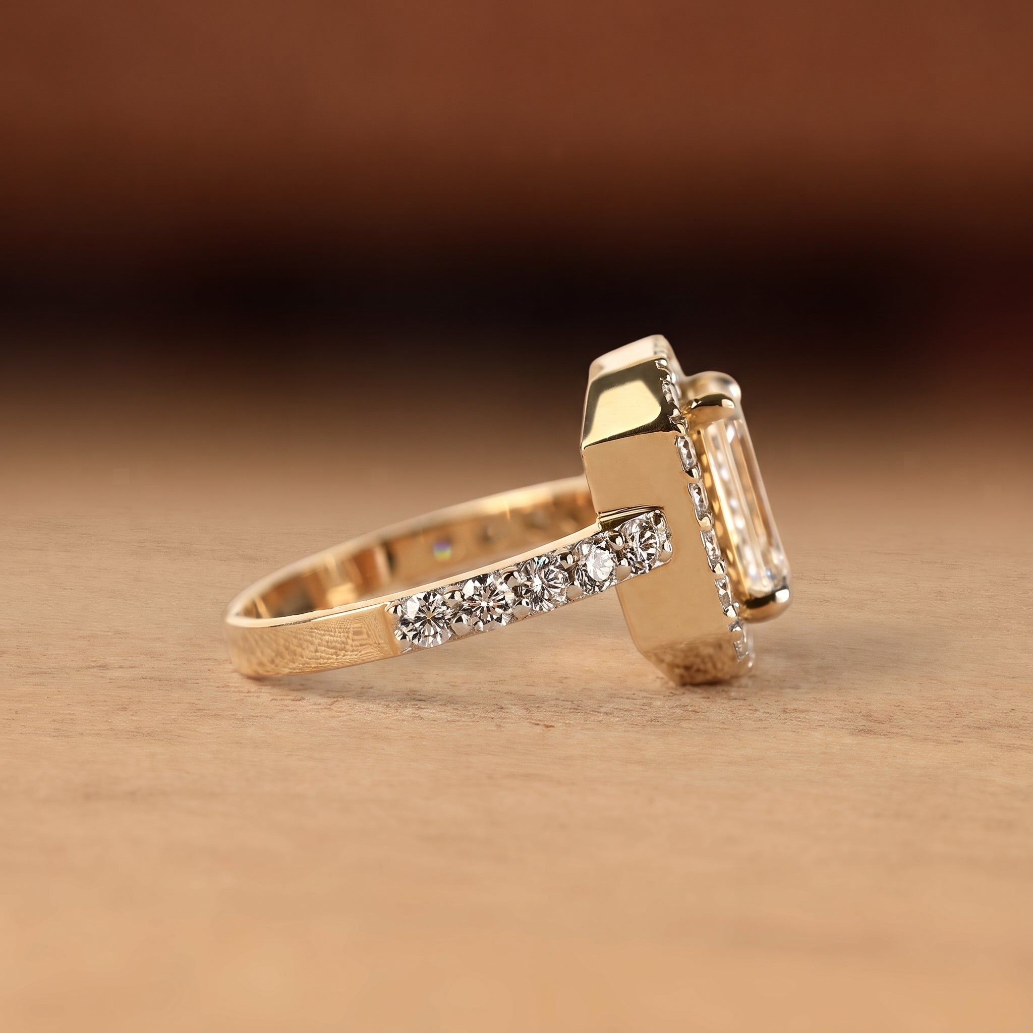 Emerald cut lab grown diamond engagement ring with round diamond halo, pave side stones, yellow gold band, IGI certified EF color VS1 clarity.