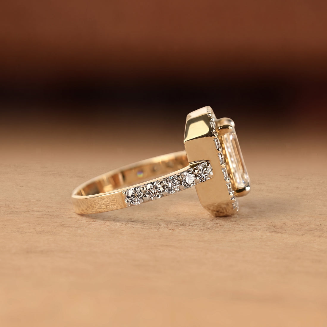 Emerald cut lab grown diamond engagement ring with round diamond halo, pave side stones, yellow gold band, IGI certified EF color VS1 clarity.