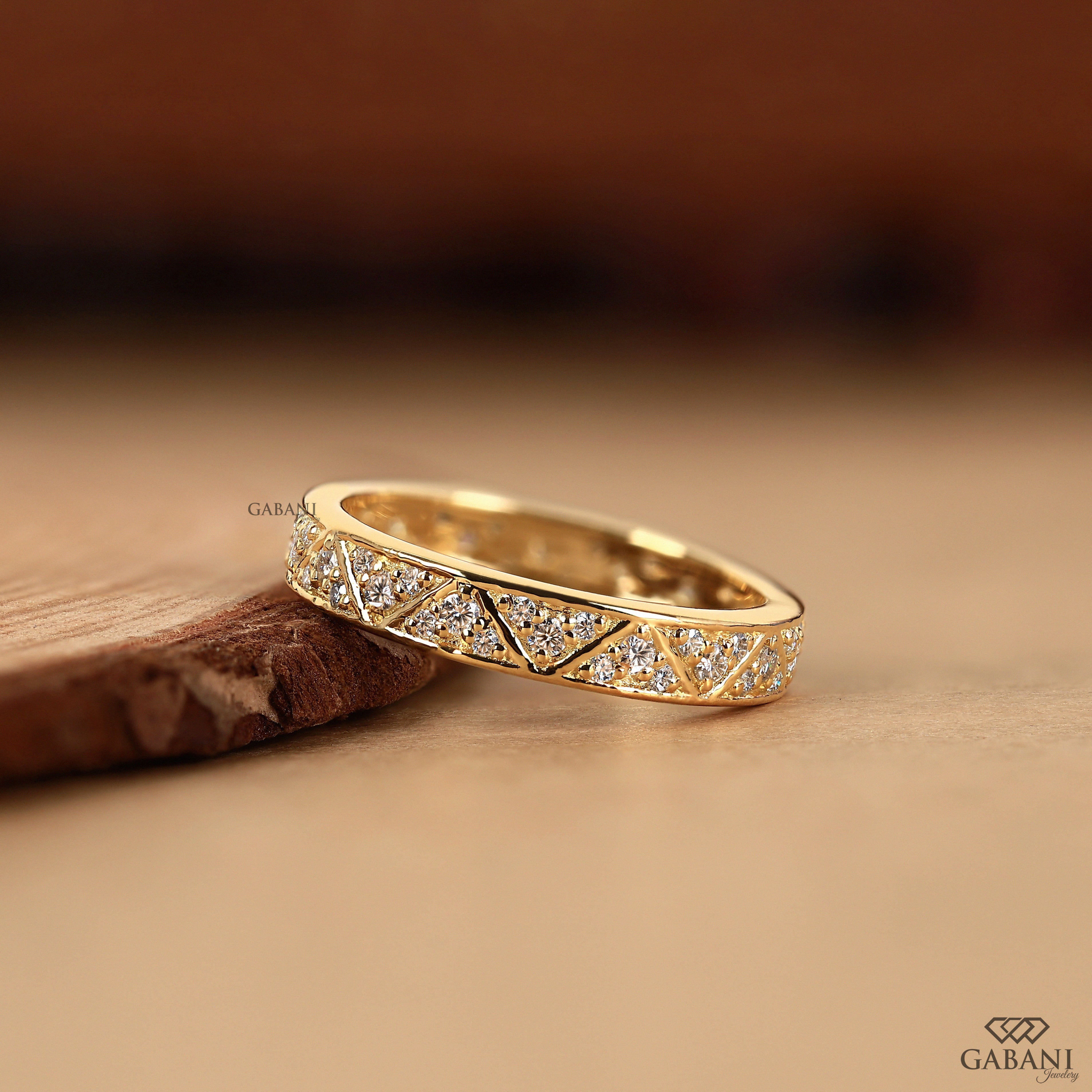 triangular pattern and polished yellow gold setting.