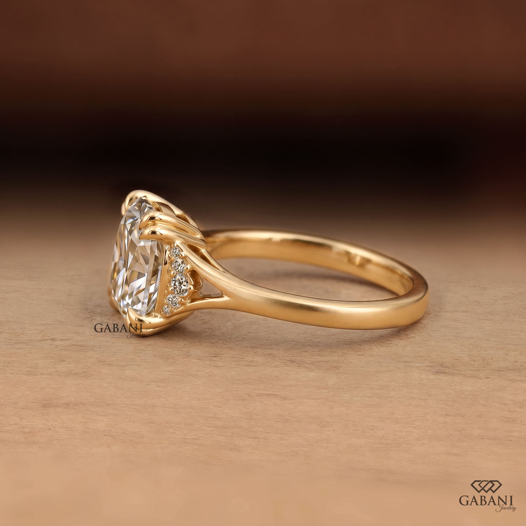 Old mine cushion cut lab grown diamond engagement ring with double claw prongs and split shank in 14K yellow gold.