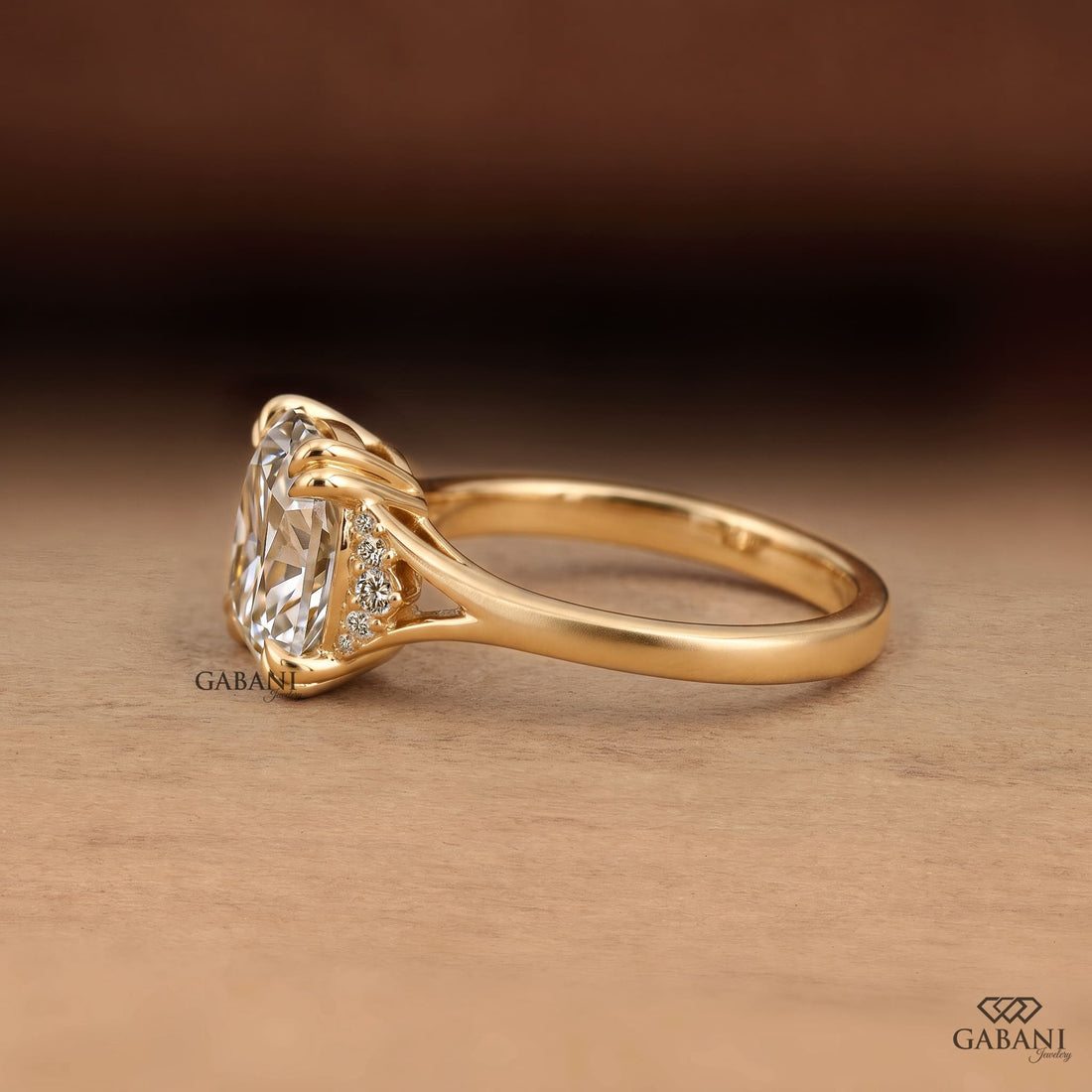 Old mine cushion cut lab grown diamond engagement ring with double claw prongs and split shank in 14K yellow gold.