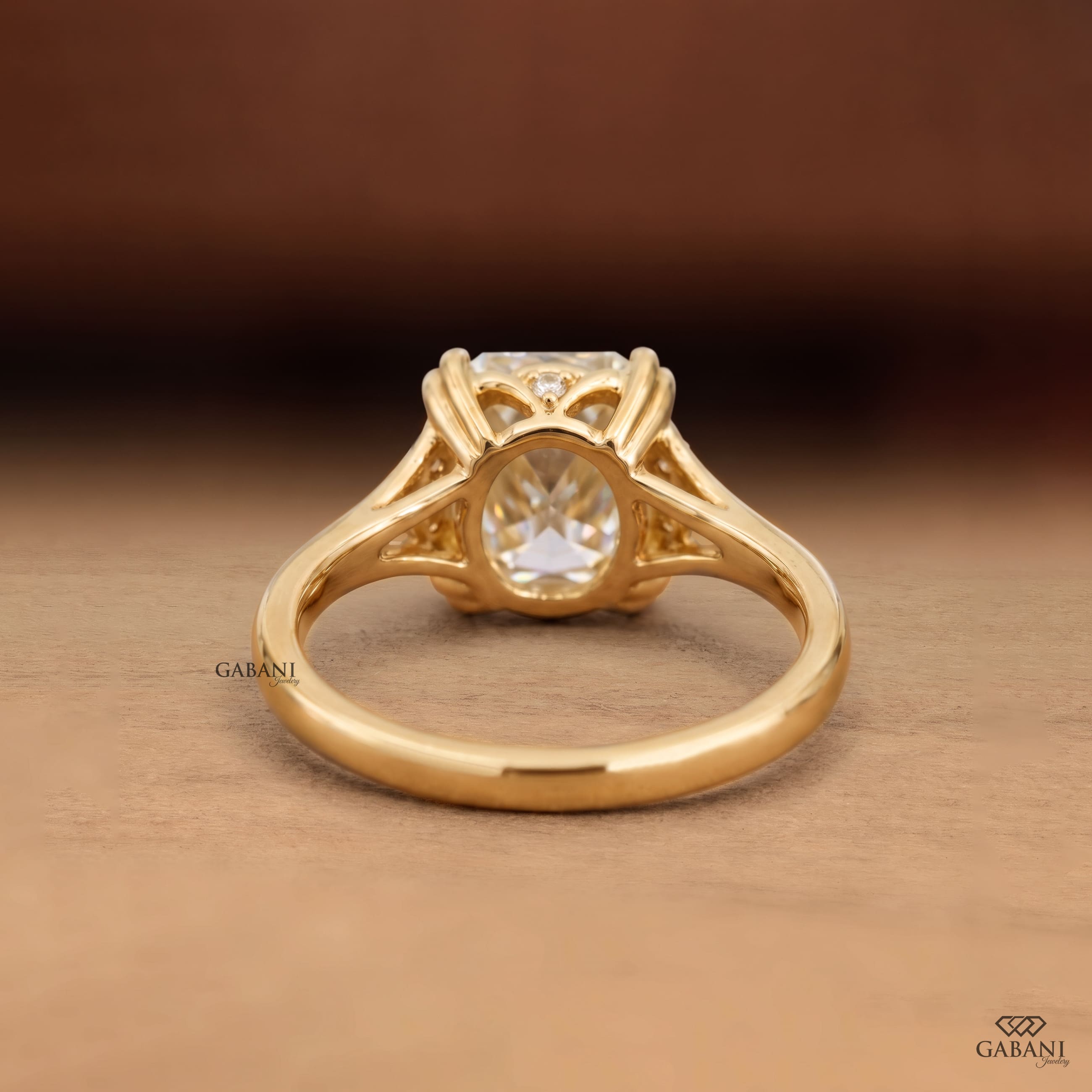 Old mine cushion cut lab grown diamond engagement ring with double claw prongs and split shank in 14K yellow gold.