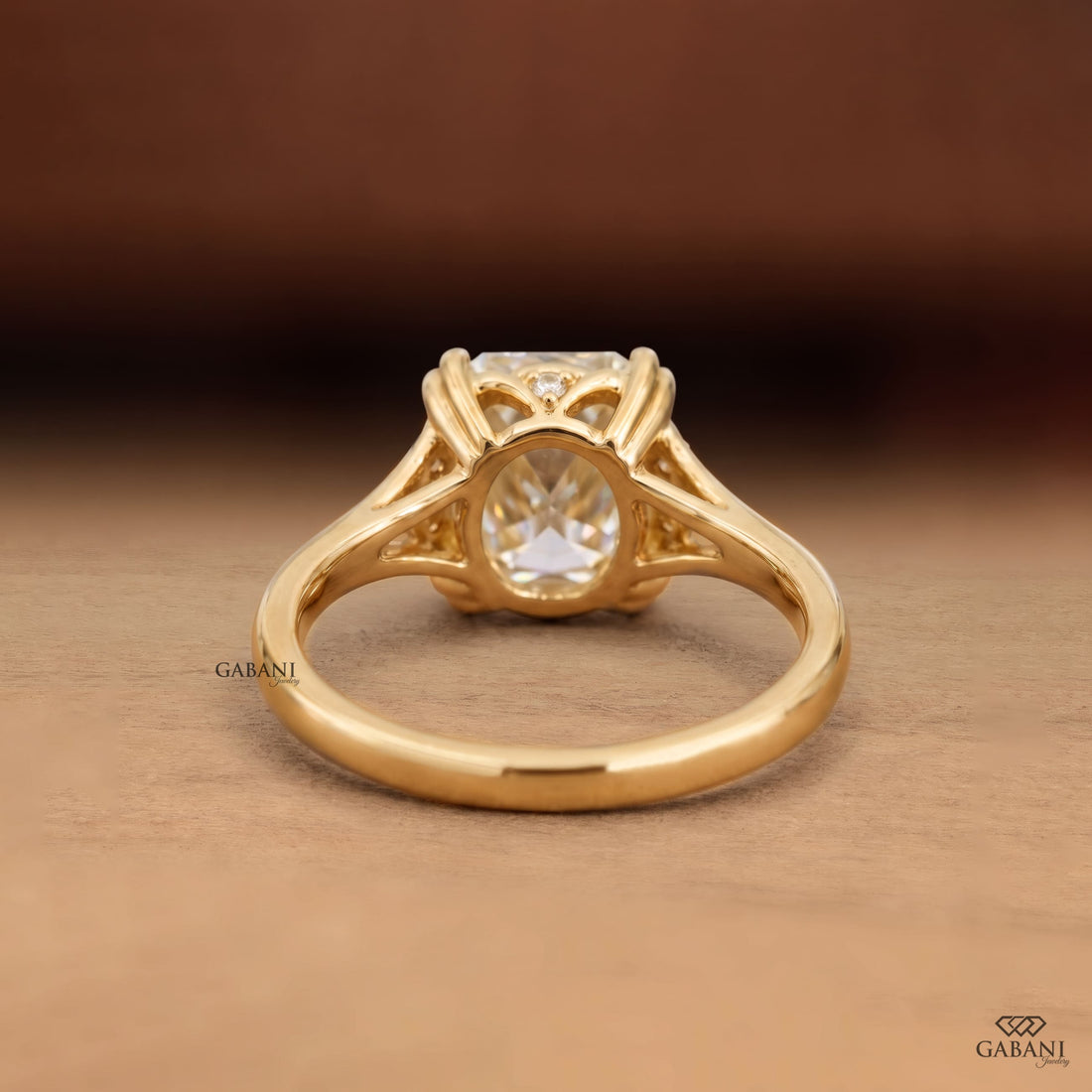 Old mine cushion cut lab grown diamond engagement ring with double claw prongs and split shank in 14K yellow gold.