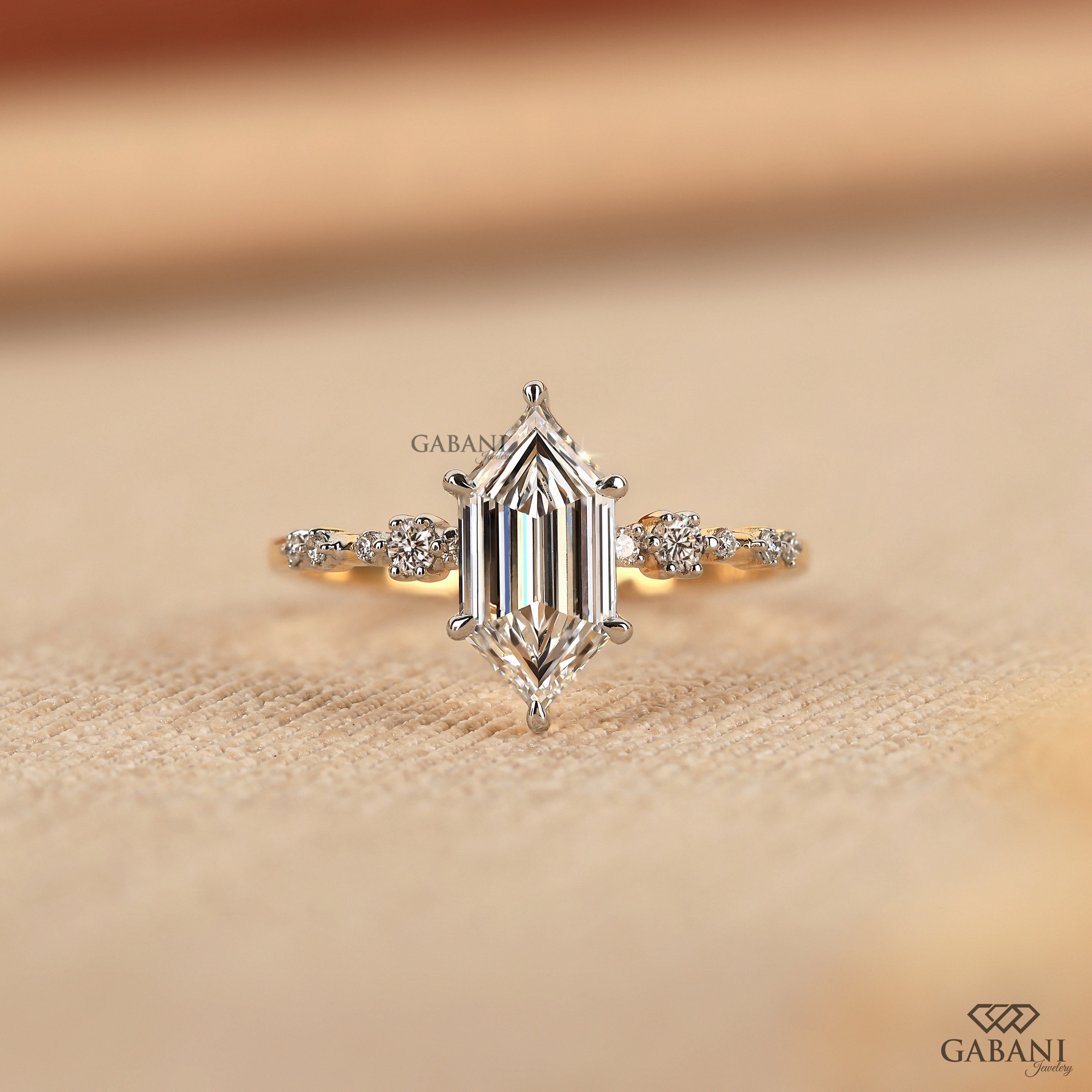 Dutch marquise lab grown diamond engagement ring with elongated geometric center stone, round side diamond accents and gold band.