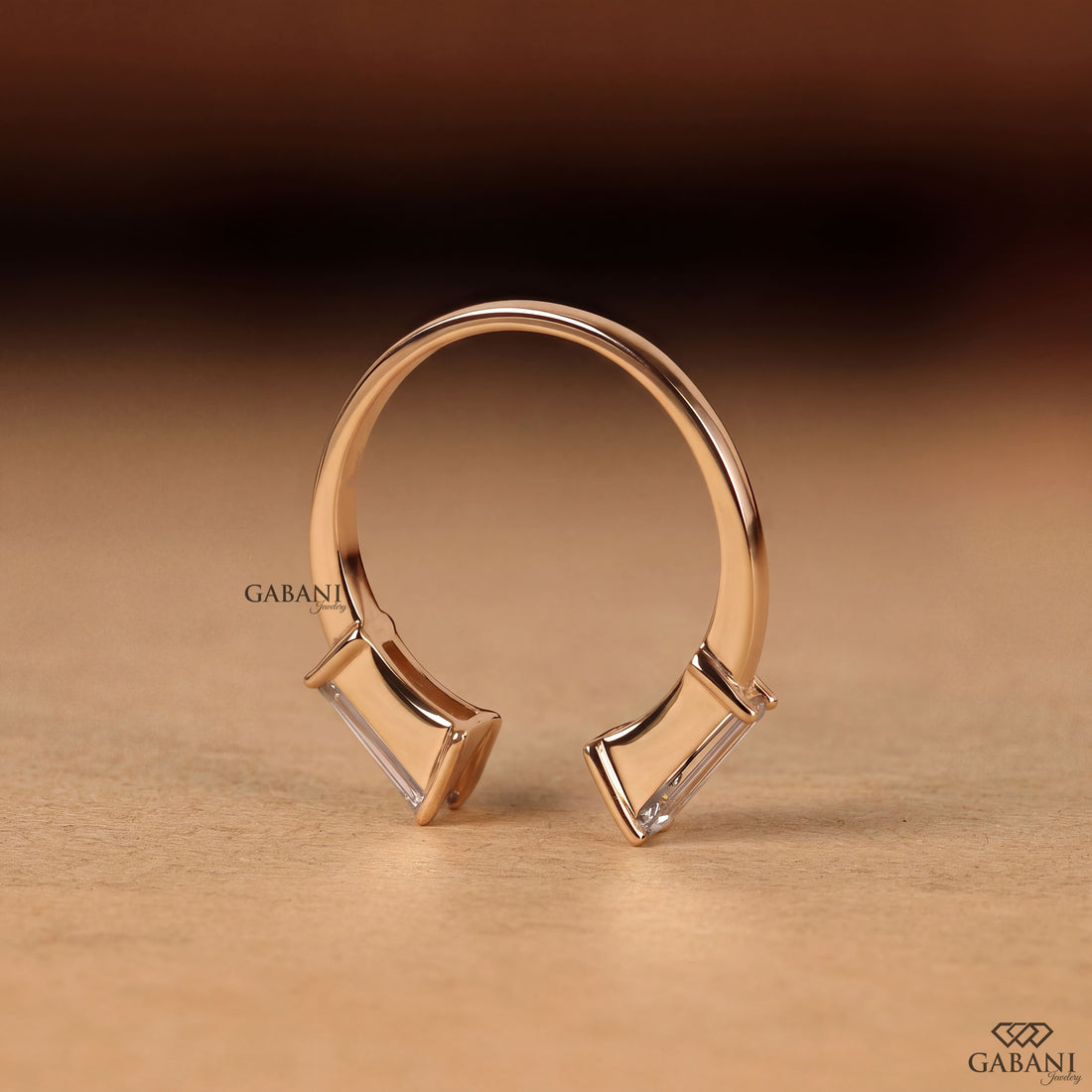 a tapered baguette cut lab grown diamond open cuff ring in 14K yellow gold, featuring two horizontally set diamonds in a modern minimalist design by Gabani Jewelry.